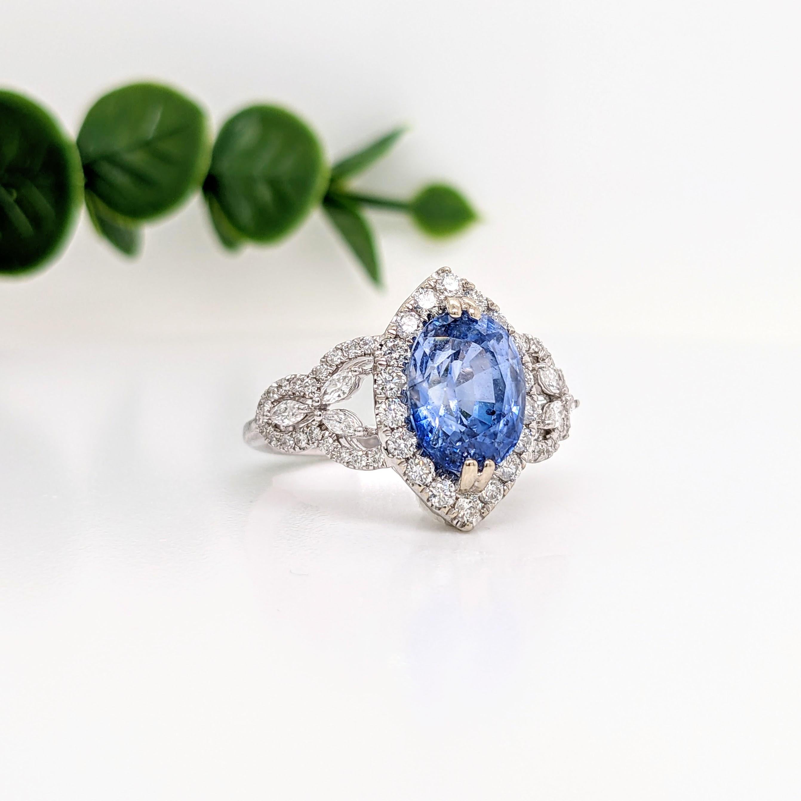 Presenting a captivating Ceylon Blue Sapphire ring that exudes elegance and allure, featuring a unique double prong North South setting and adorned with exquisite natural earth-mined round and marquise diamond accents. Crafted from solid 14k white