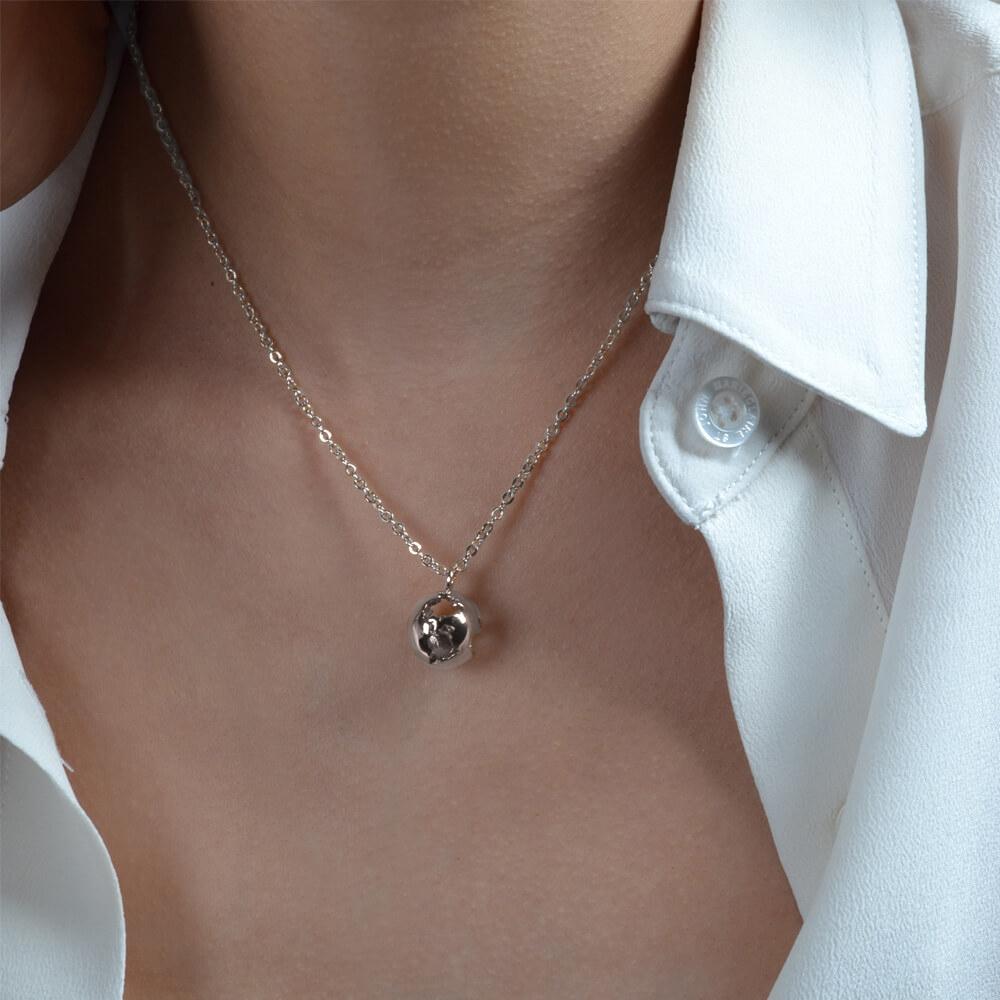 This beautiful Earth Necklace features an intricate design that illustrates a world map, dangles in a delicate chain. Available in two striking finishes — Rhodium Plated Brass. This classic and elegant necklace is a constant reminder for the travel