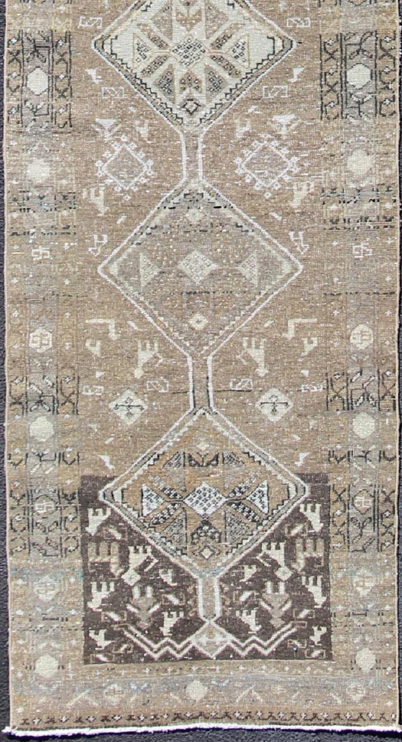 Tribal diamond medallion antique Heriz runner Persian in taupe, camel, brown, rug zir-20, country of origin / type: Iran / Heriz, circa 1910

This antique Persian Heriz gallery rug, circa early 20th century, features a unique blend of colors and