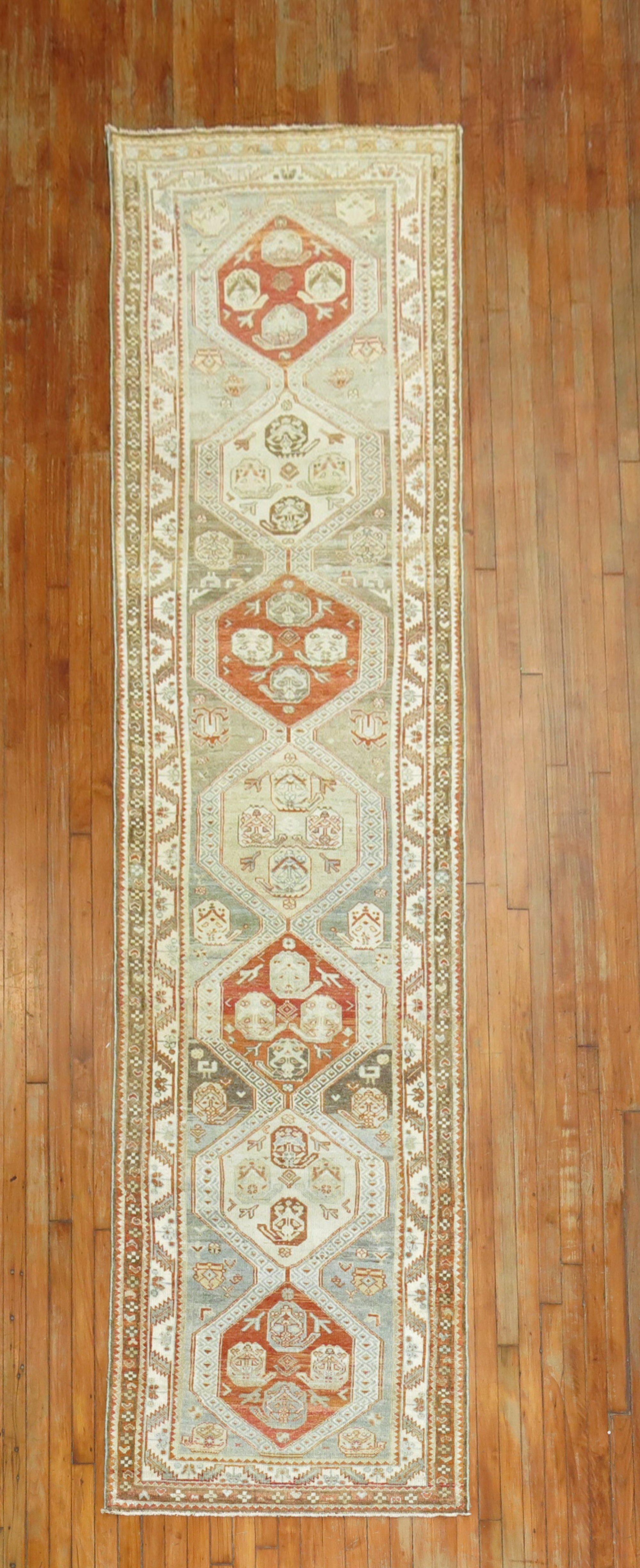 Tappeto persiano Malayer dell'inizio del XX secolo nei toni del blu, del marrone e dell'albicocca.

Misure: 3'2'' x 12'.

