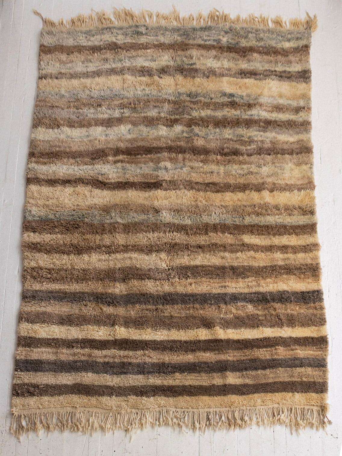Extra soft high pile Moroccan wool rug. Neutral pallet with shades ranging from browns to beiges and grays.