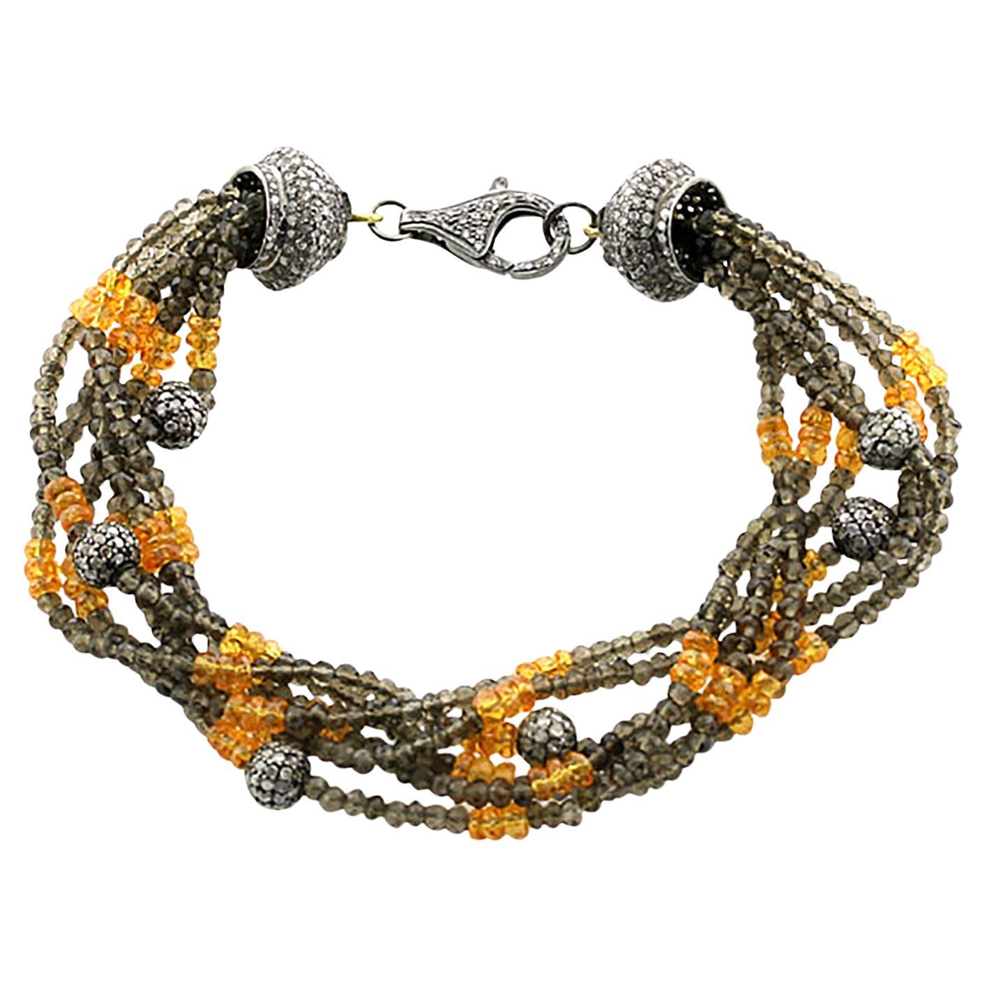 Bracciale di lusso sui toni della terra: Gioielli con quarzo fumé, granato e diamanti