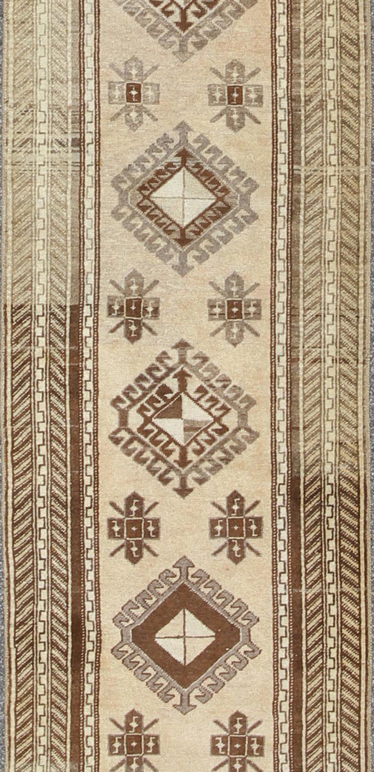 Hand-Knotted Earth-Toned Vintage Turkish Oushak Runner with Stacked Medallion Design For Sale