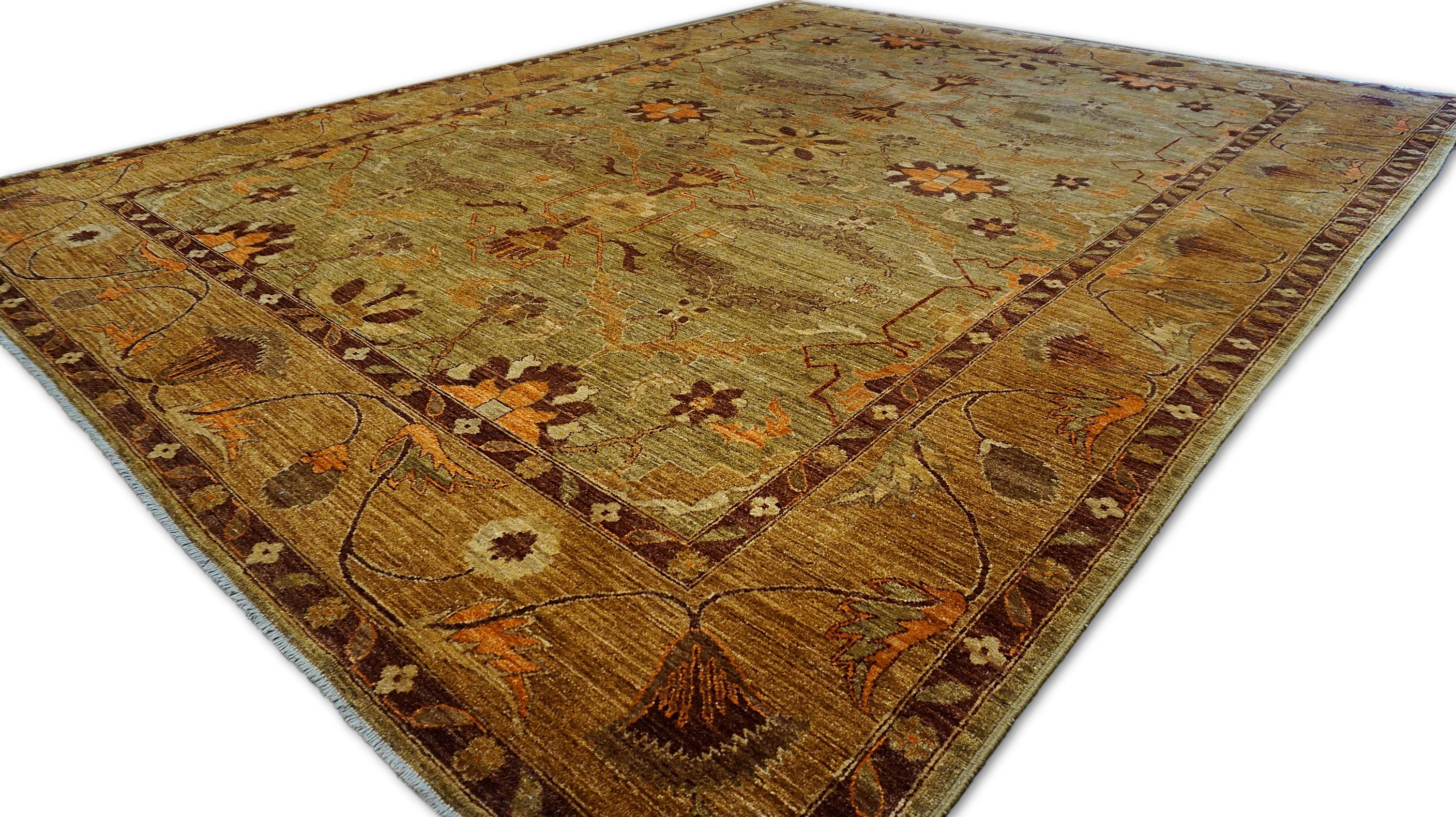 This exquisite hand-knotted wool rug captures the essence of timeless elegance with its rich, botanical-inspired design. Crafted by skilled artisans using hand-spun wool, this piece features a harmonious blend of earthy green and warm rust tones,