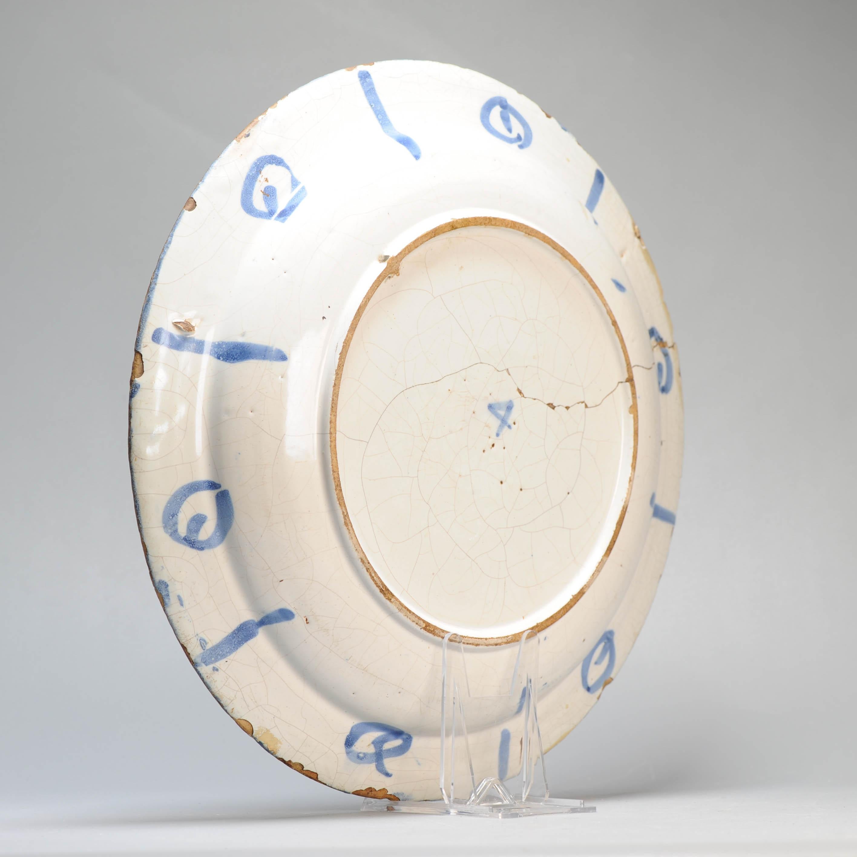 Plato de barro con borde plano. Decorado en diferentes tonos de azul sobre un whi en venta 9