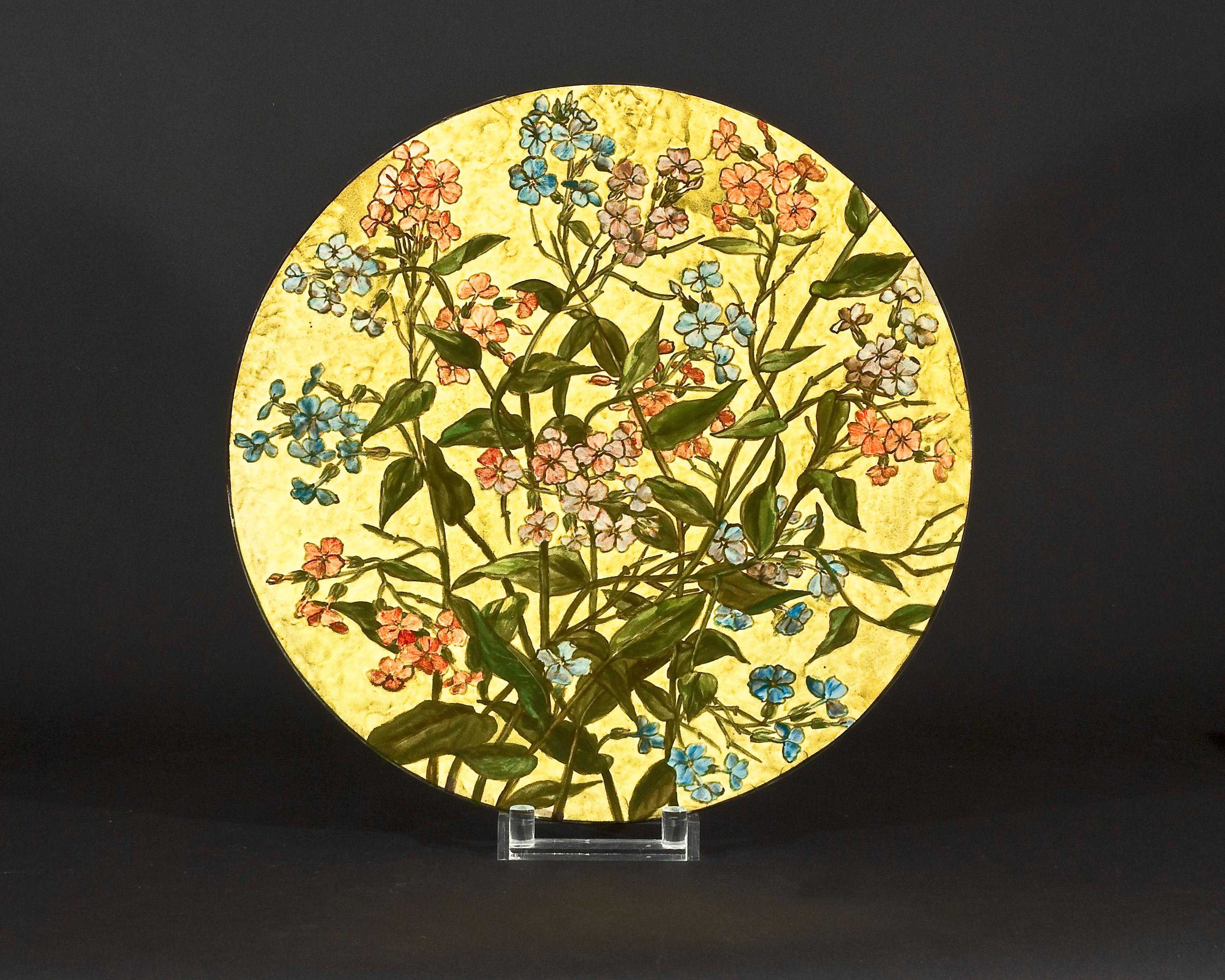 FAPG 20247D
John Bennett (1840-1907), New York
Plaque with pink and blue phlox, circa 1881-1882
Earthenware, painted and glazed
Measures: 14 7/8 in. diameter, 1 13/16 in. high
Signed and inscribed (on the back): J B[monogram] ENNETT / 
E 24