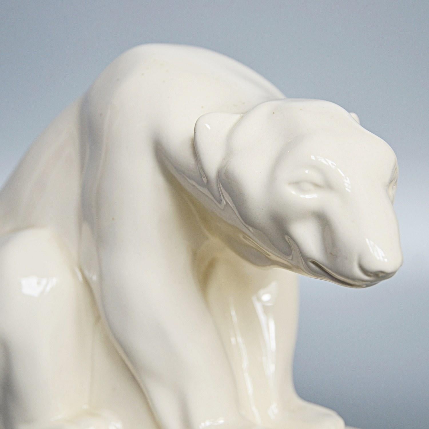 An earthenware model of a polar bear by John Skeaping for Wedgwood. Cream glazed with printed Wedgwood marks to underneath. 

Dimensions: H 18cm, W 24cm, D 18cm 

Origin: English

Date: circa 1960

Item number: 2409203.