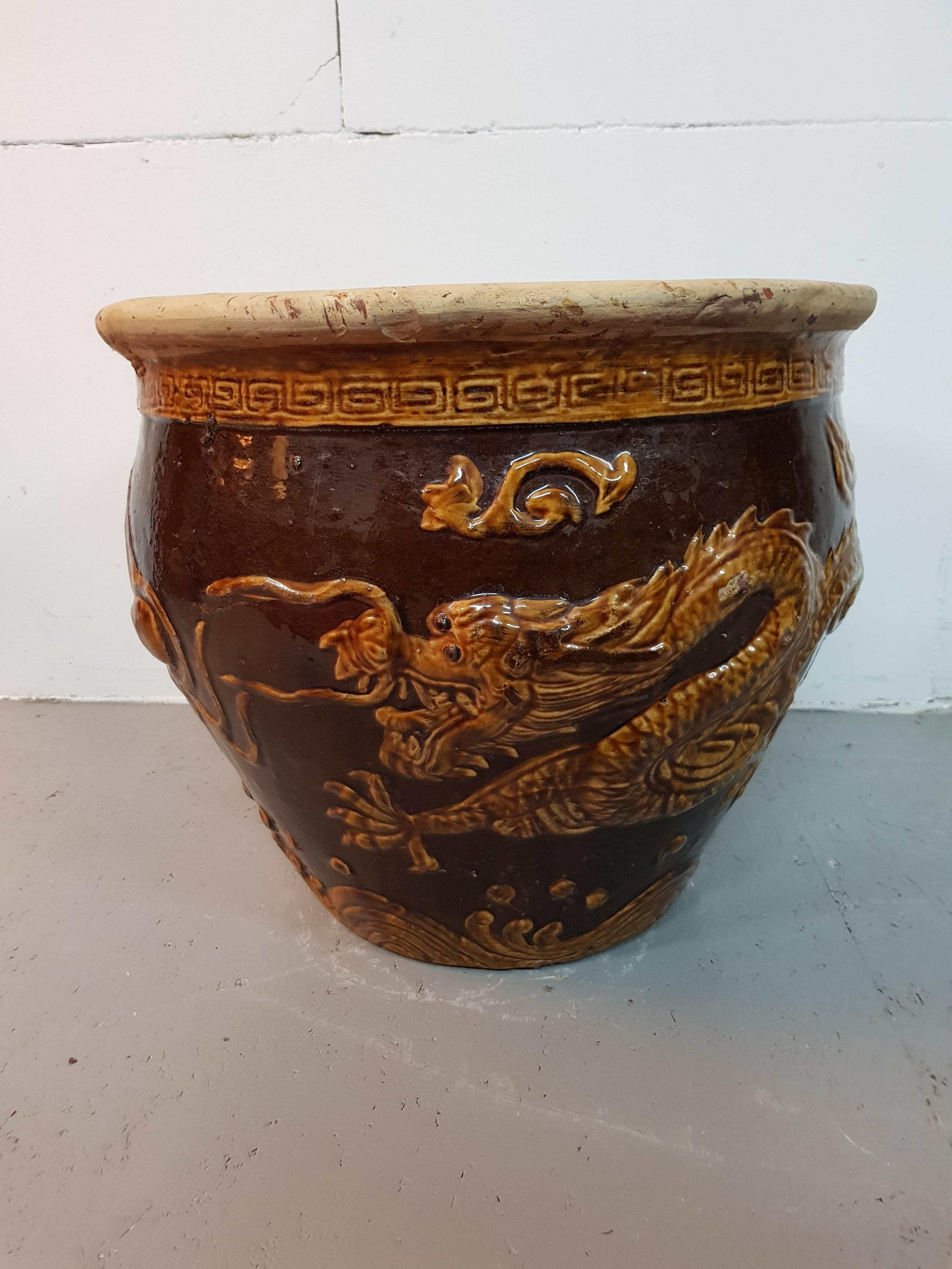 Chinese earthenware flower box with relief of dragons and is marked but unknown and further in a good condition with slight traces of use, second half of 20th century.

The measurements are,
Depth 47 cm/ 18.5 inch.
Width 47 cm/ 18.5