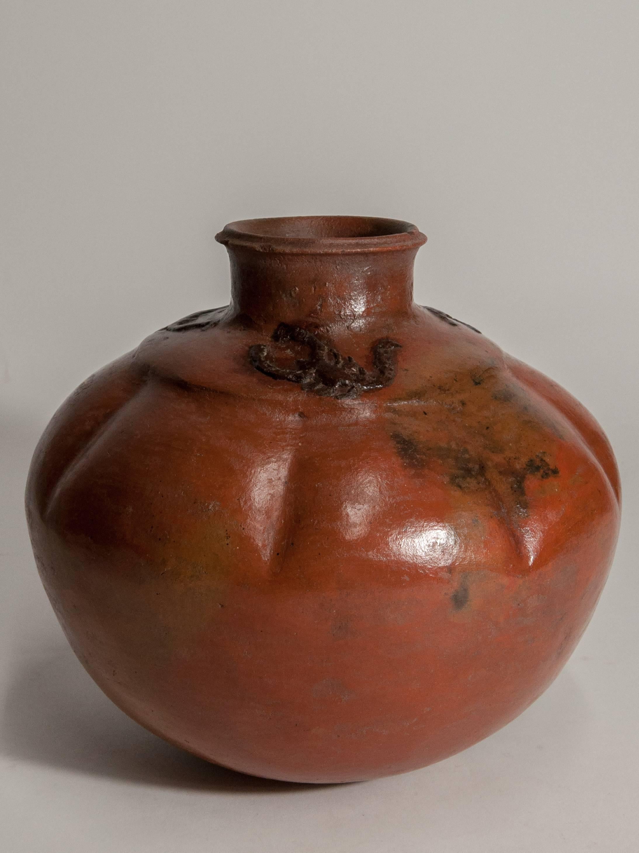 Earthenware pot with scorpion motifs surrounding the base of the neck. Sumba island. East Indonesia, mid-late 20th century.
This low fired, hand formed and burnished pot comes from Sumba island in east Indonesia and would have been used to store