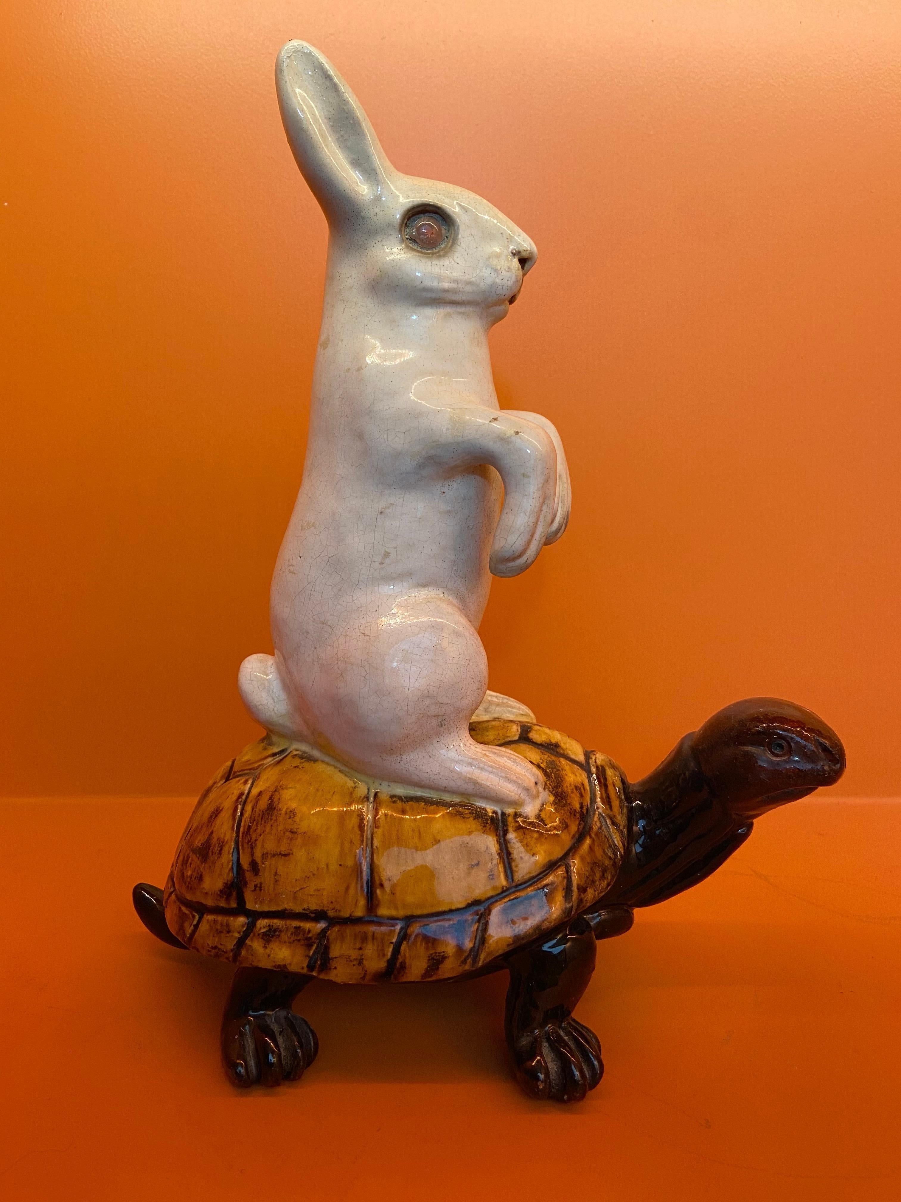 This earthenware is showing a rabbit on a turtle. This is a French work, attributed to famous designer and maker Emile Galle. Circa end of 19th century.