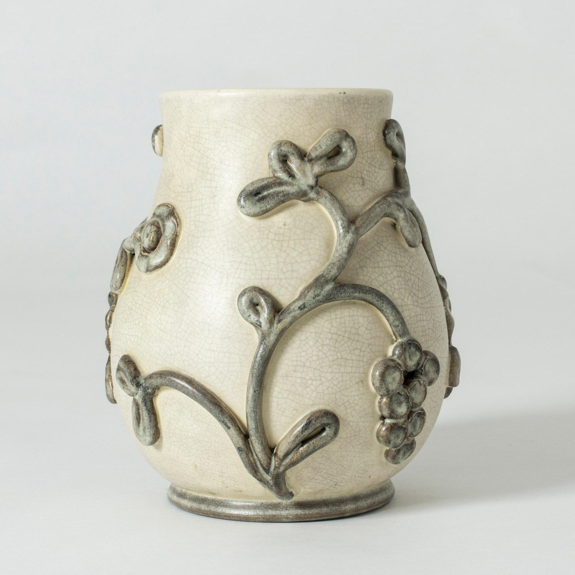 Beautiful earthenware vase by Eva Jancke-Björk. Muted natural tones in off-white and grey. Decor of a stylized grape vine with thick glaze.