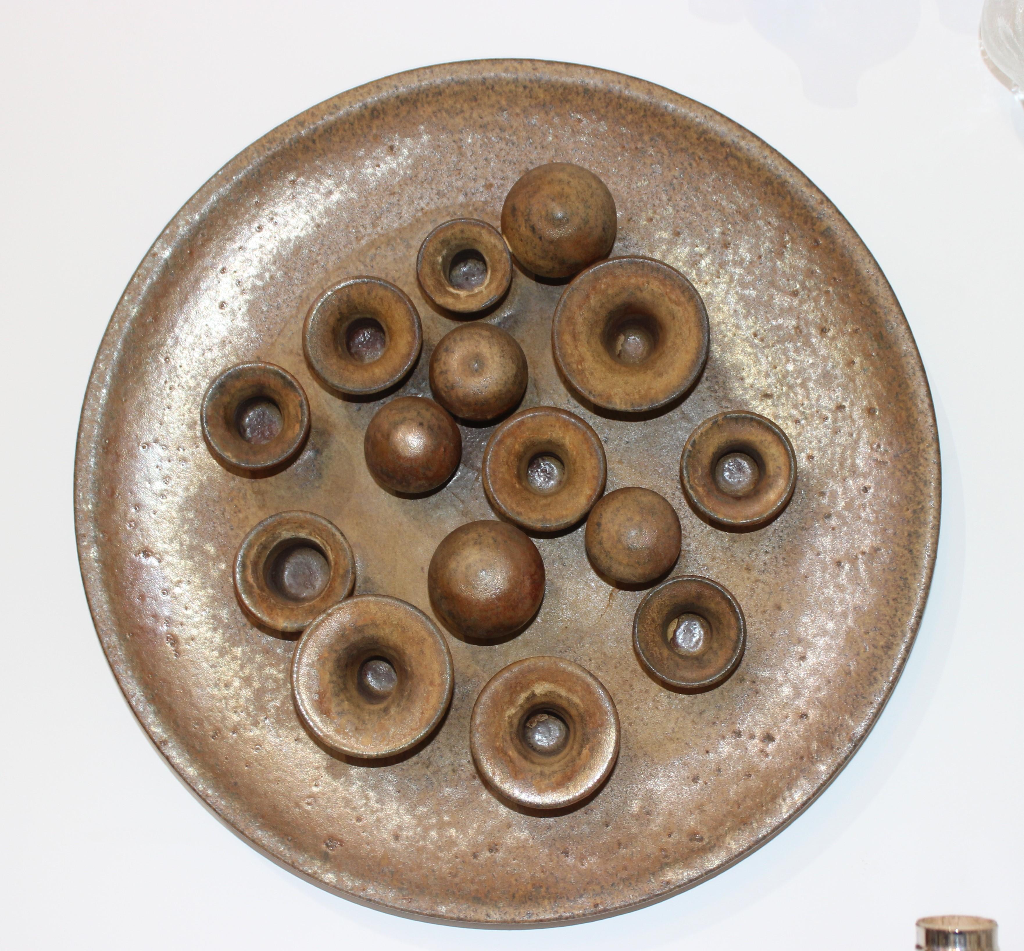Earthenware round motif wall sculpture signed on verso Mid-Century Modern, Italy

This midcentury artisan piece can be hung on the wall or sit flat on a tabletop and could be also used as a candleholder.

Note: the last picture shows the