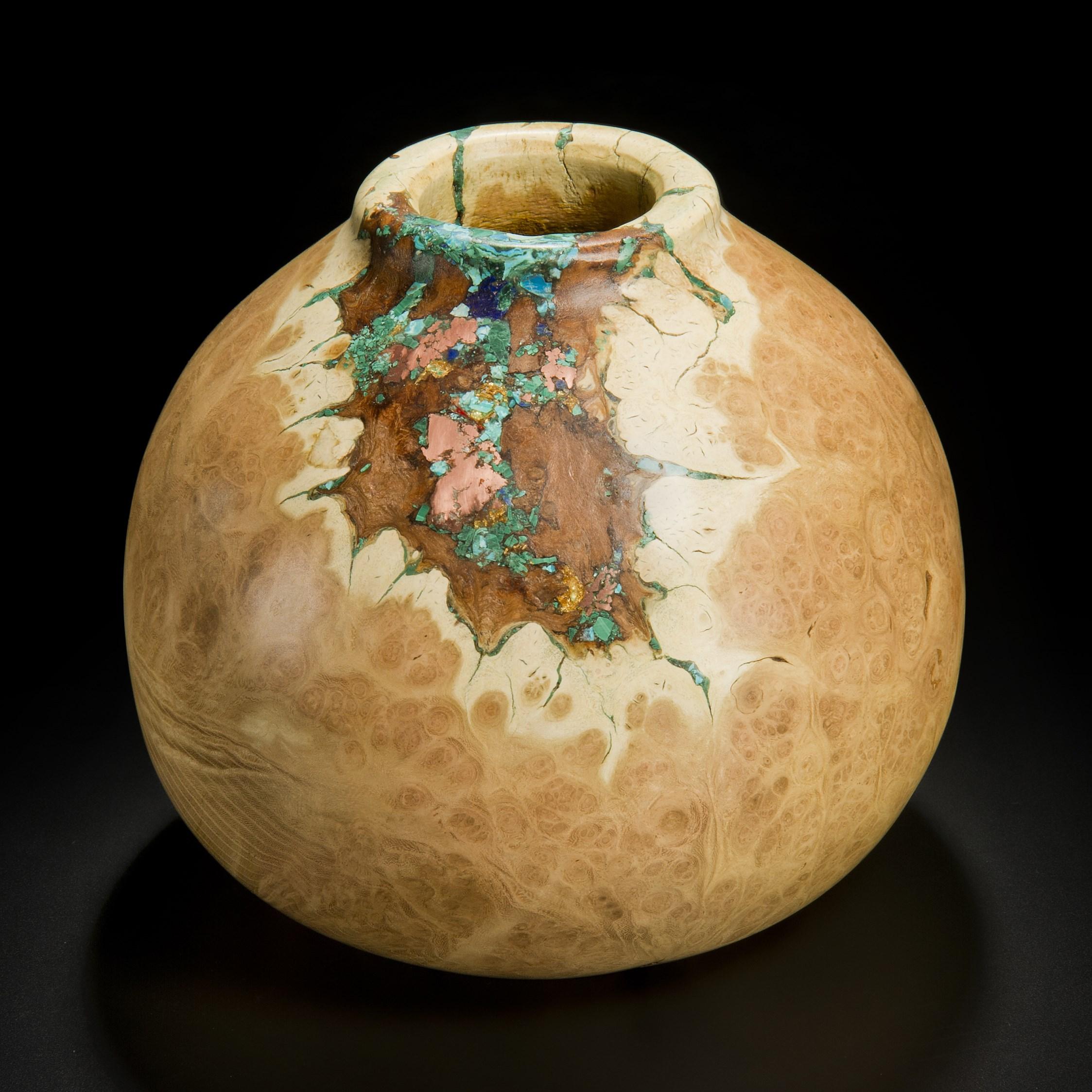 ‘Earthly Treasures No 25’ is a unique sculptural bowl by the British artist, Morrison Thomas. It is made from burred Acacia inlaid with Native Copper, Malachite, Gold, Chrysocolla & Turquoise.

Morrison turns beautiful wooden spheres from damaged