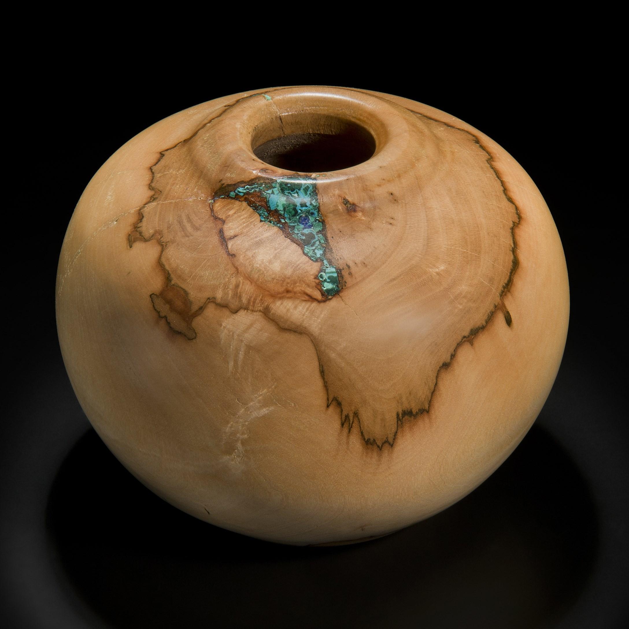 ‘Earthly Treasures No 26’ is a unique sculptural bowl by the British artist, Morrison Thomas. It is made from sycamore inlaid with Chrysocolla & Malachite.

Morrison turns beautiful wooden spheres from damaged or diseased trees that have been