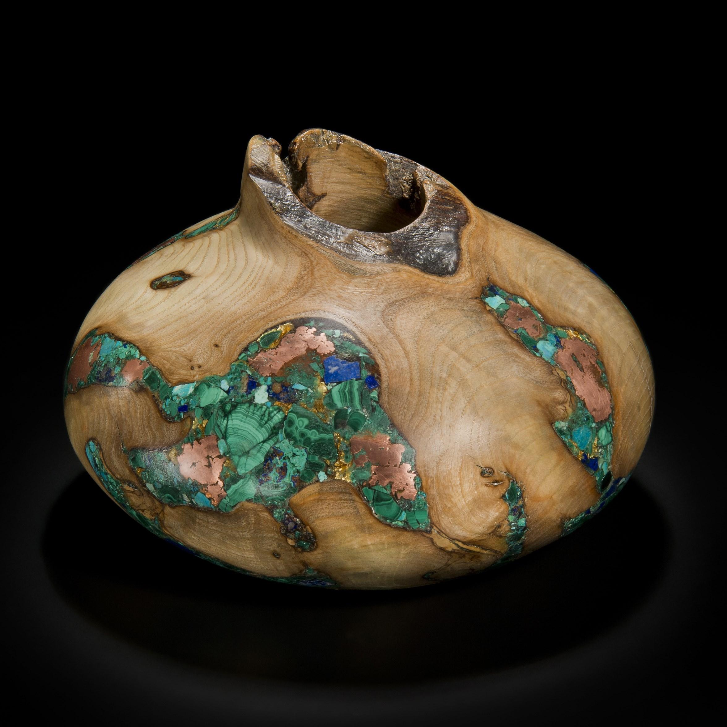 ‘Earthly Treasures No 30’ is a unique sculptural bowl by the British artist, Morrison Thomas. It is made from cankered Ash inlaid with Malachite, Chrysocolla, Lapis Lazuli, Native Copper and Gold.

Morrison turns beautiful wooden spheres from