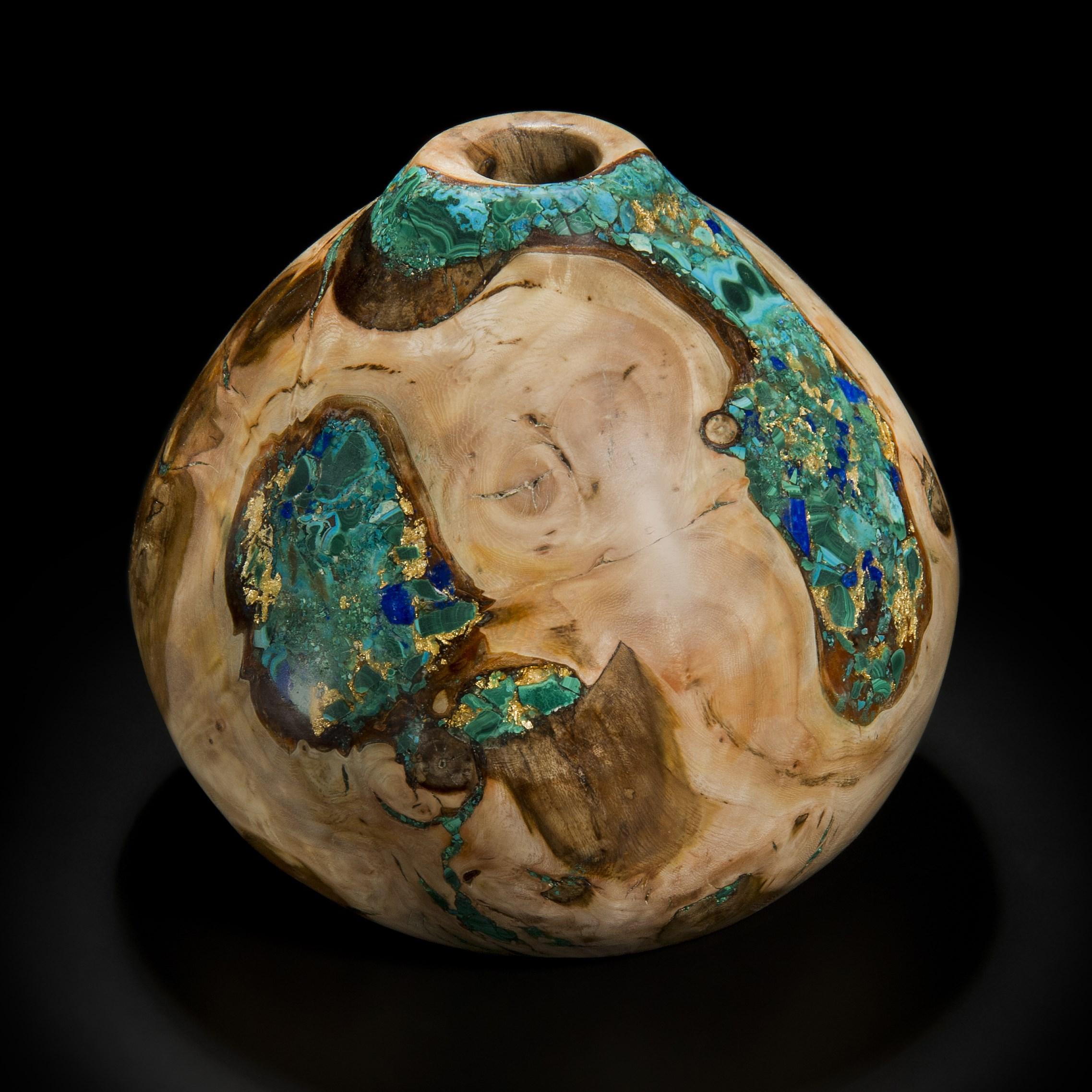 ‘Earthly Treasures No 31’ is a unique sculptural bowl by the British artist, Morrison Thomas. It is made from polarded Burr Elm inlaid with Malachite, Chrysocolla, Lapis Lazuli, Azurite and Gold.

Morrison turns beautiful wooden spheres from