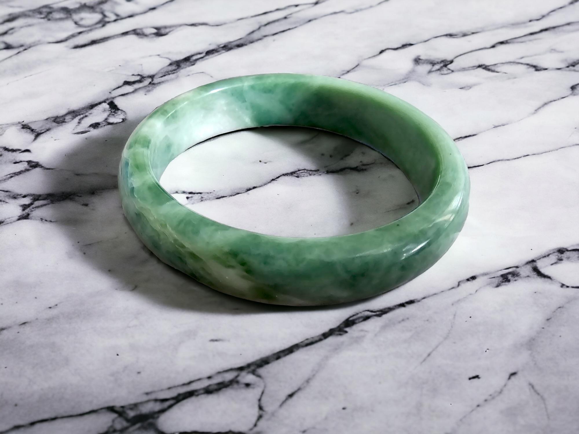 Burmese A-Jadeite Jade Bangle Bracelet; Green, Grey, White Jadeite 08808

Our 'Earth's' Bangle Bracelets are all one-of-one pieces;

This piece is famed for its unique green, grey and white hues with fantastic translucency and optics. The marbling