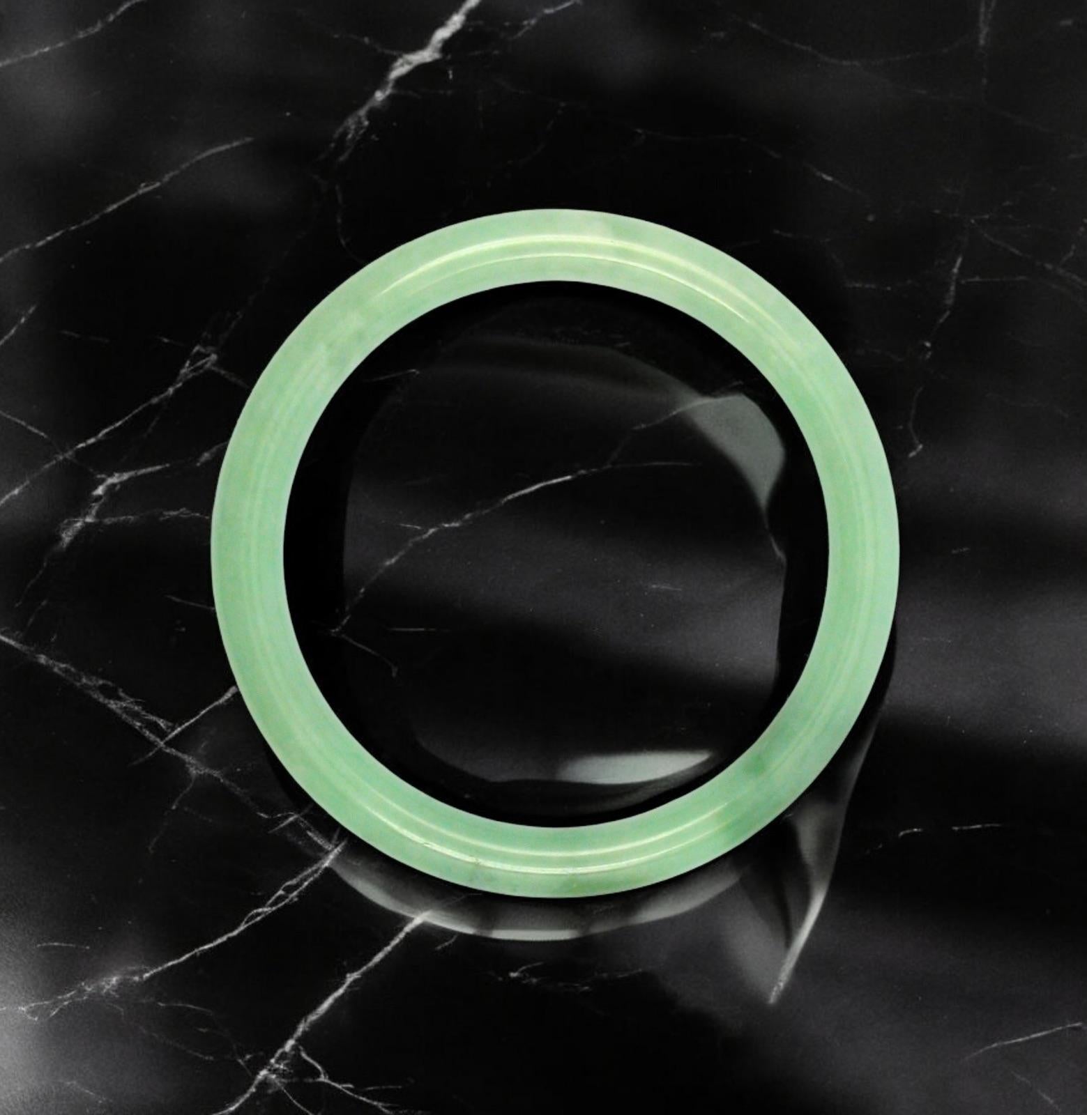 Using the best Handpicked untreated natural A-Jadeite from Burma, we created an authoritative and classy statement bangle bracelet. This unique block of Jadeite has Deep Green marbling, patches and splashes of Vivid Green and white. Interlaced with