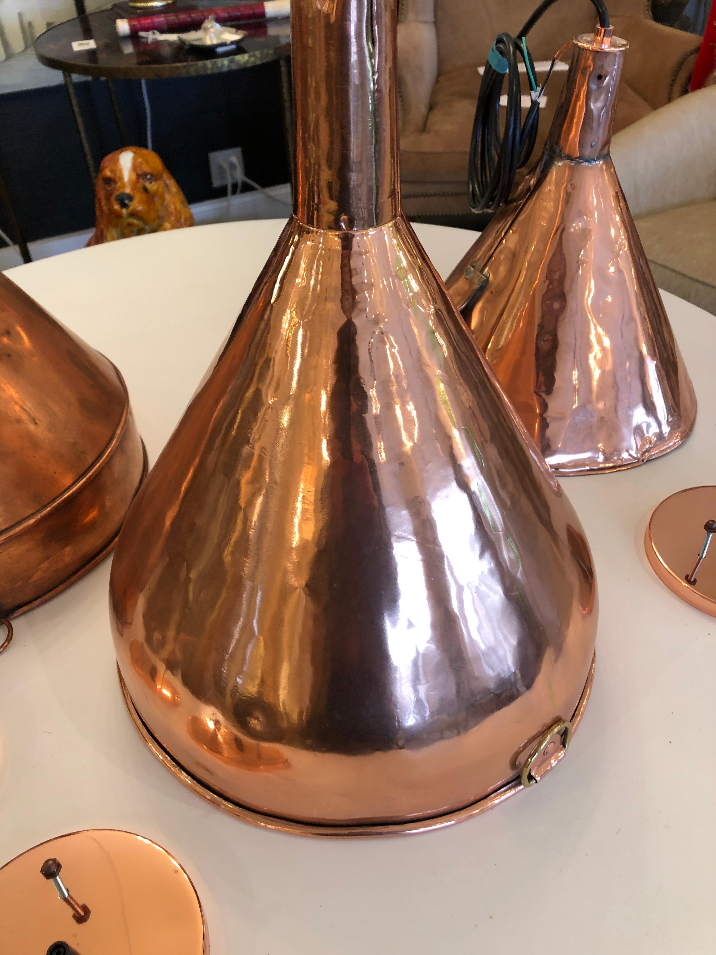 Beautiful antique copper funnel cleverly transformed into a hanging electrified pendant.
One 60 watt bulb.

Note: Two other different funnels are also available to make an interesting trio.