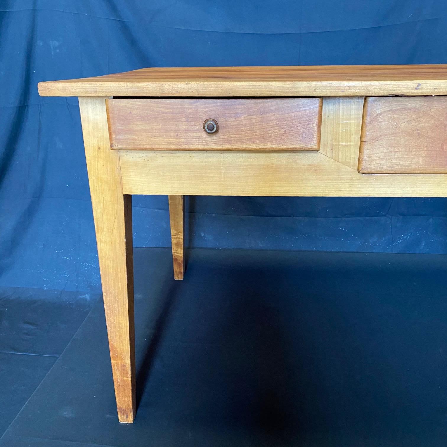 This early but refinished pine table from Lyon, France has a rich patina and two drawers and could be used as a desk, side table or small dining table. Apron is 21.25 from floor
#5310.
  