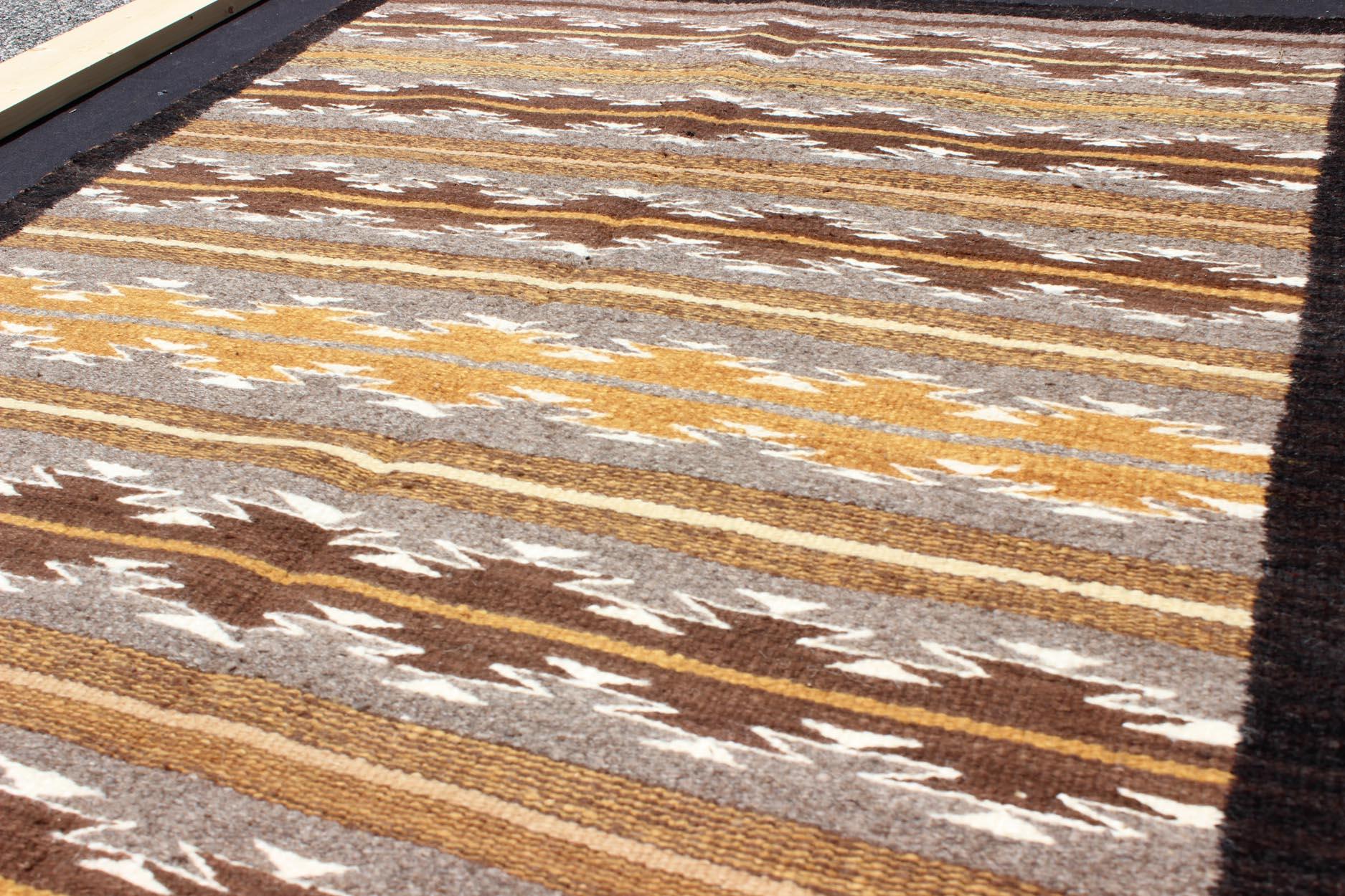 Hand-Woven Earthy Tones USA Navajo Kilim rug with Black Border Tribal Design For Sale