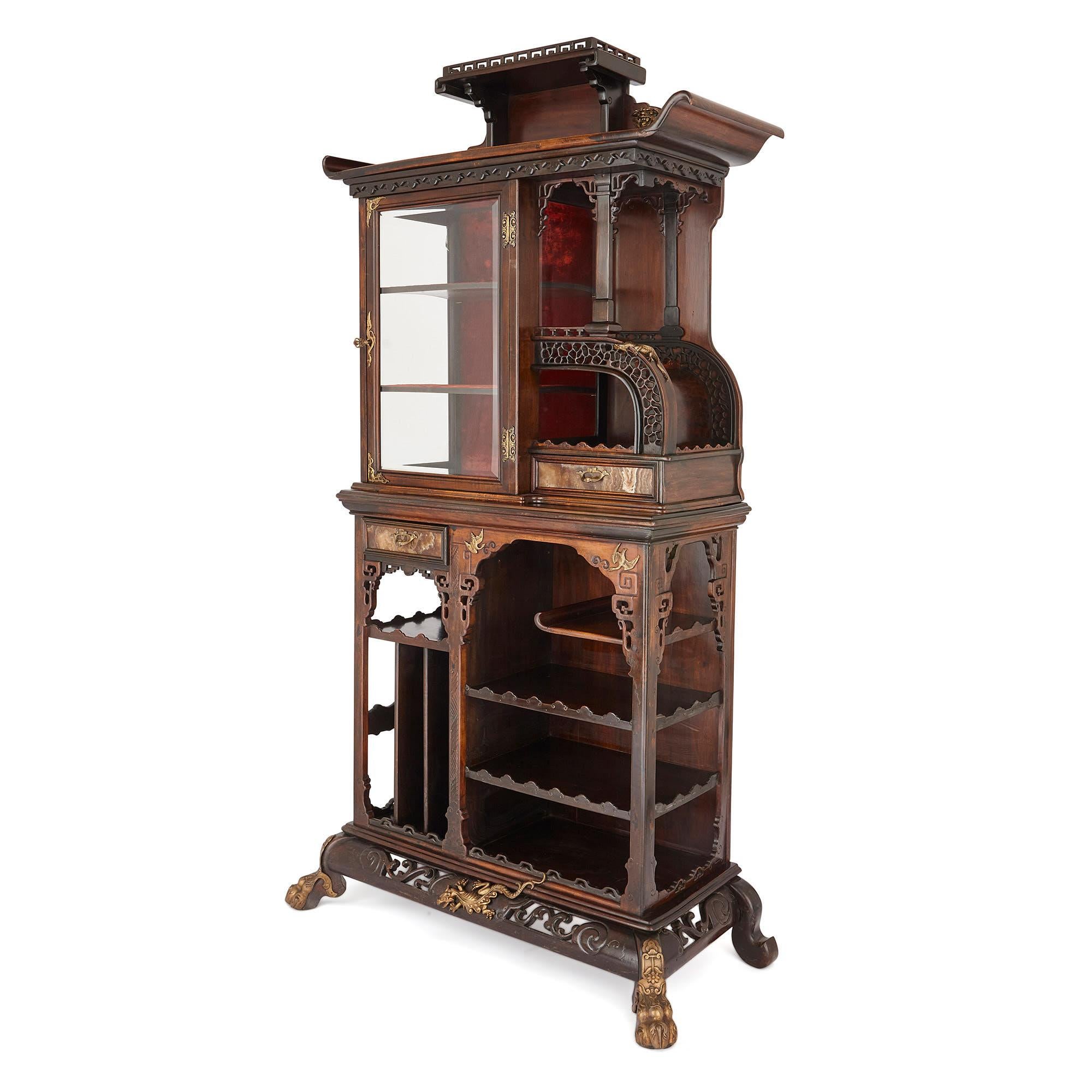 This display cabinet is designed in the East Asian style, which was popular in France in the 19th century. It has been crafted from beechwood, and painted with a glaze to make it imitate the finish on Chinese and Japanese furniture. 

The cabinet