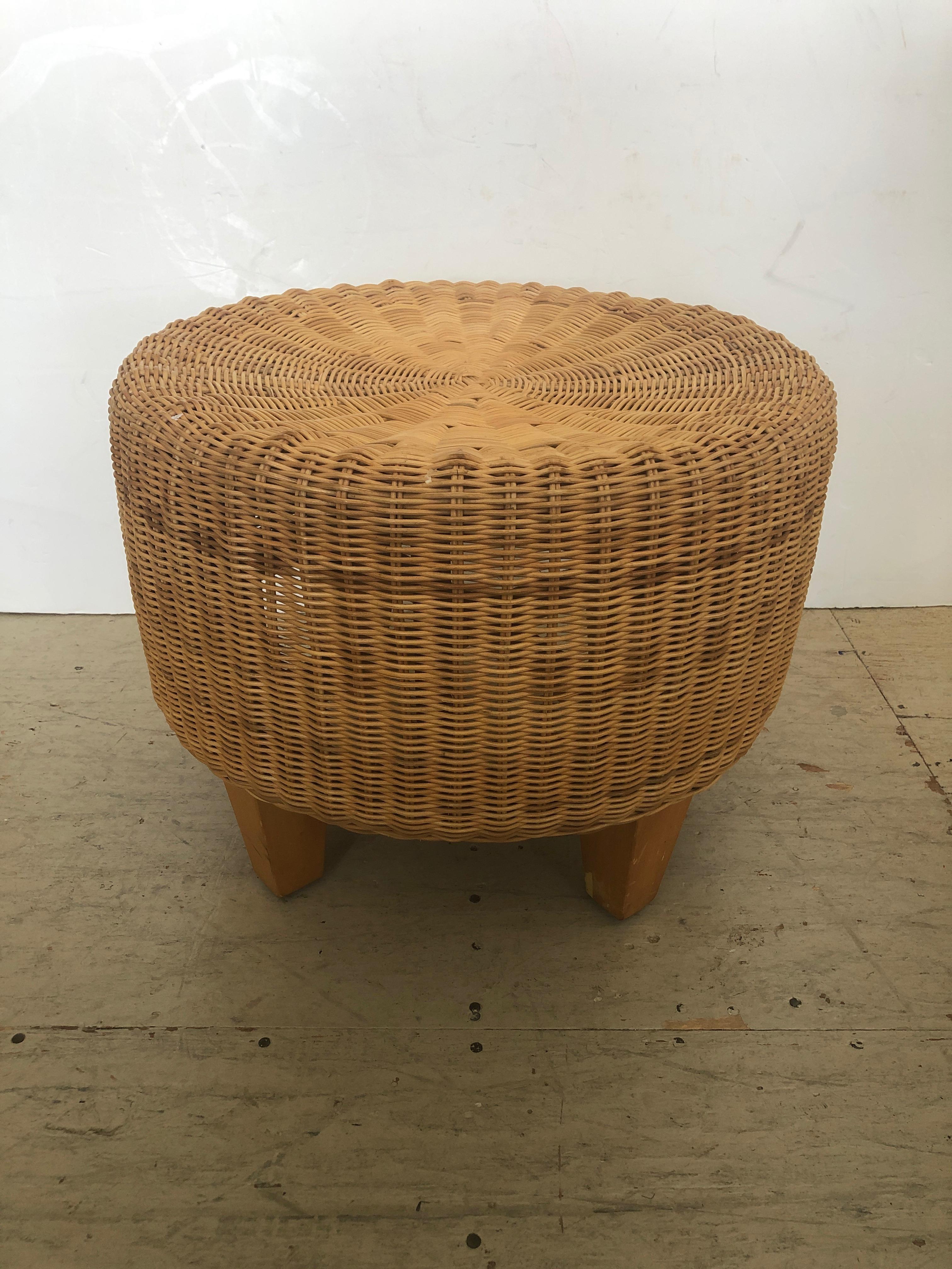 Great looking woven rattan and wicker round ottoman having 4 tapered light wood legs. Perfect for a stylish beach house.  NOTE:  Pair available as shown.  One darker than the other.