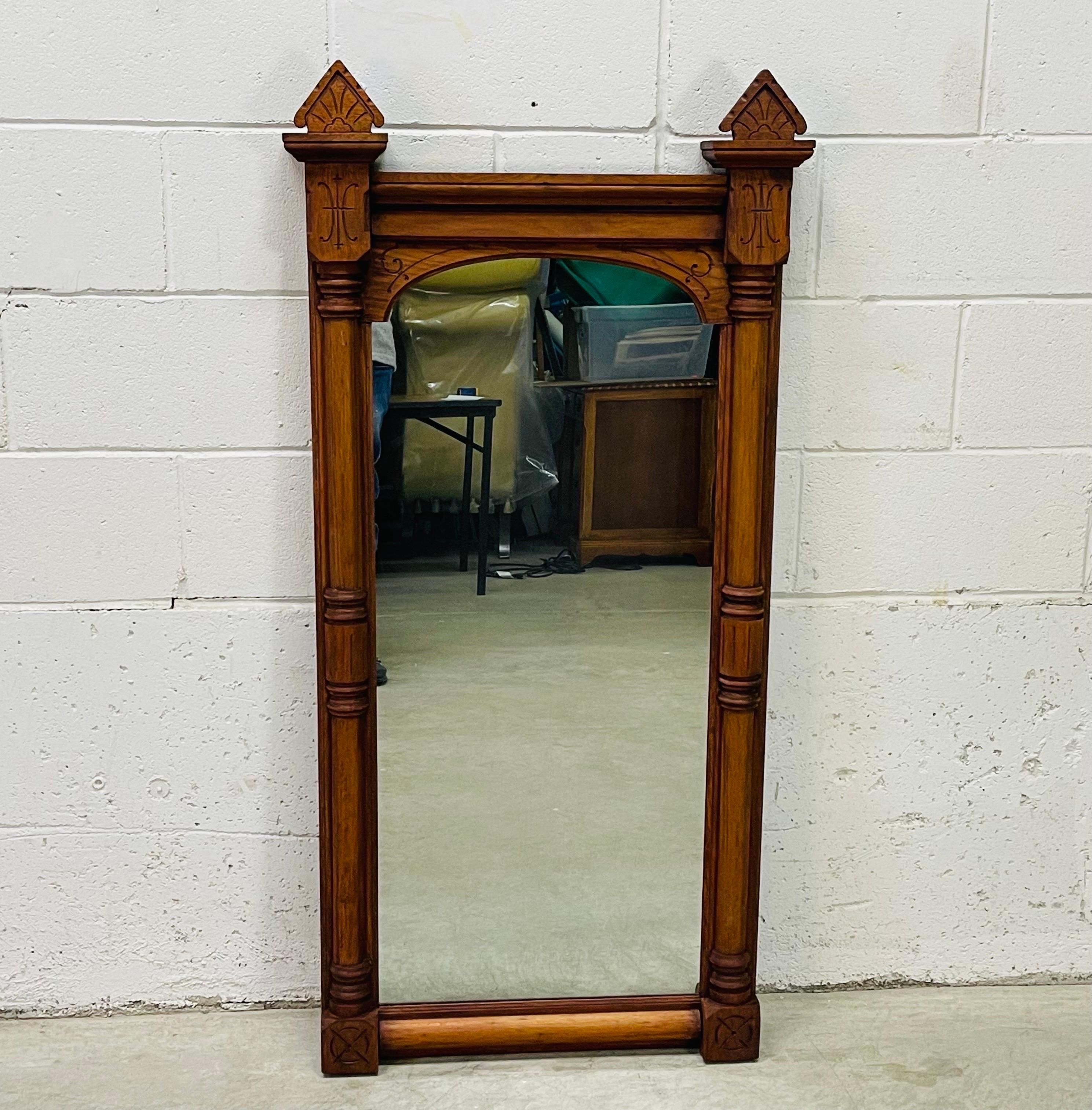 Antique East Lake style victorian black walnut hand carved large wall mirror. Intrique carved details over the entire mirror. Original mirror. Newly refinished condition. Hardware included.