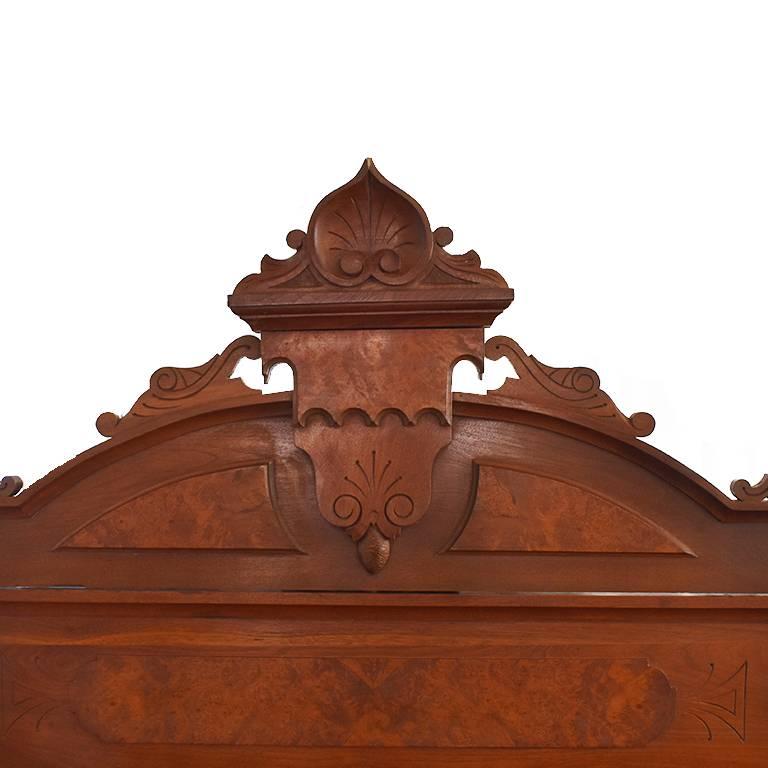 Beautiful hand-carved bed complete with sideboards, headboard and foot board. Beautiful burl wood details. Full size. Some wear on the inside of the rails and at the end of the headboard and footboard and a small portion of the curve on the end of
