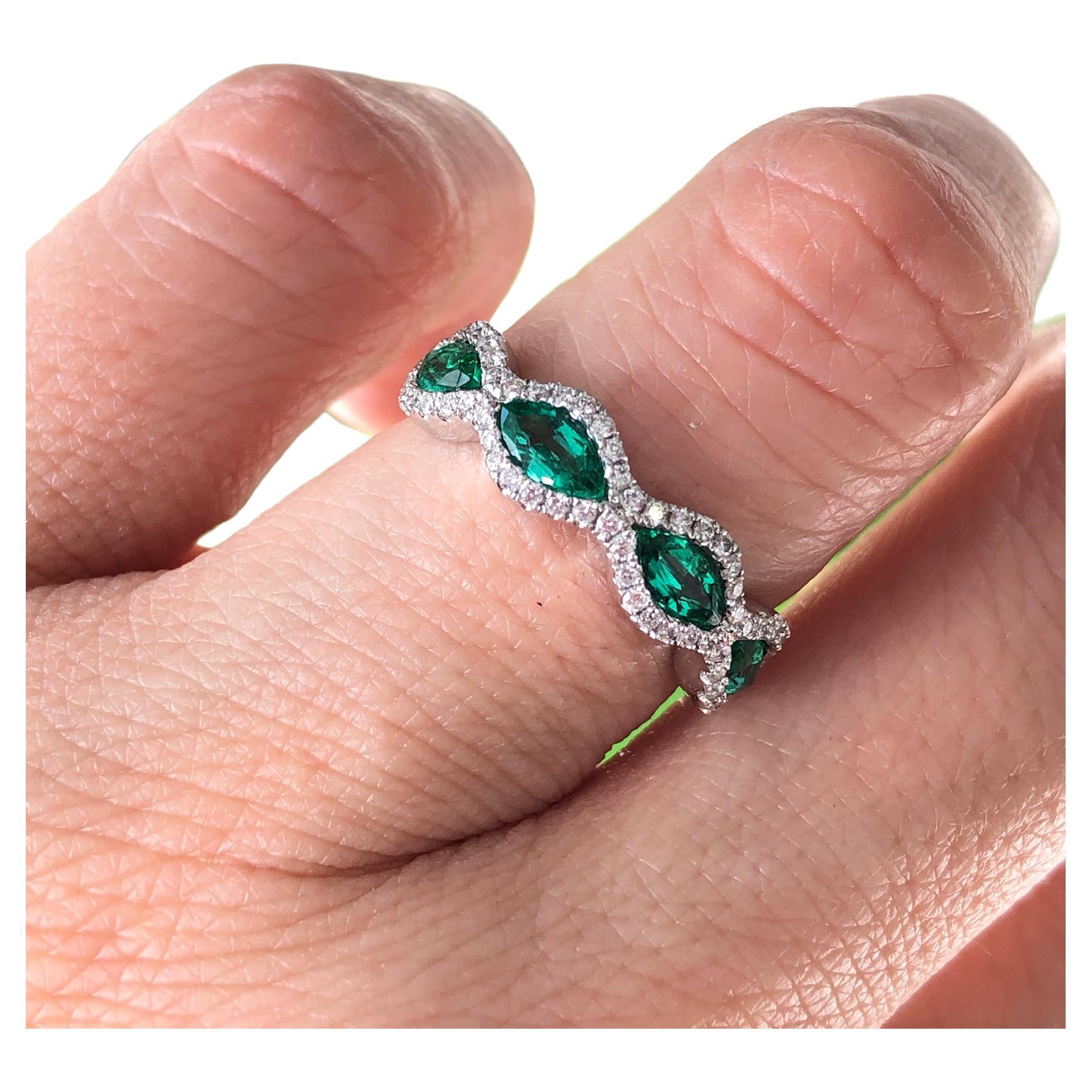 18K white gold, marquis emeralds and diamond ring, mounted east to west

Features
18K white gold mounting
.82 carat total weight marquis emeralds
.27 carat total weight in diamonds
Ring size 6, can be sized. 