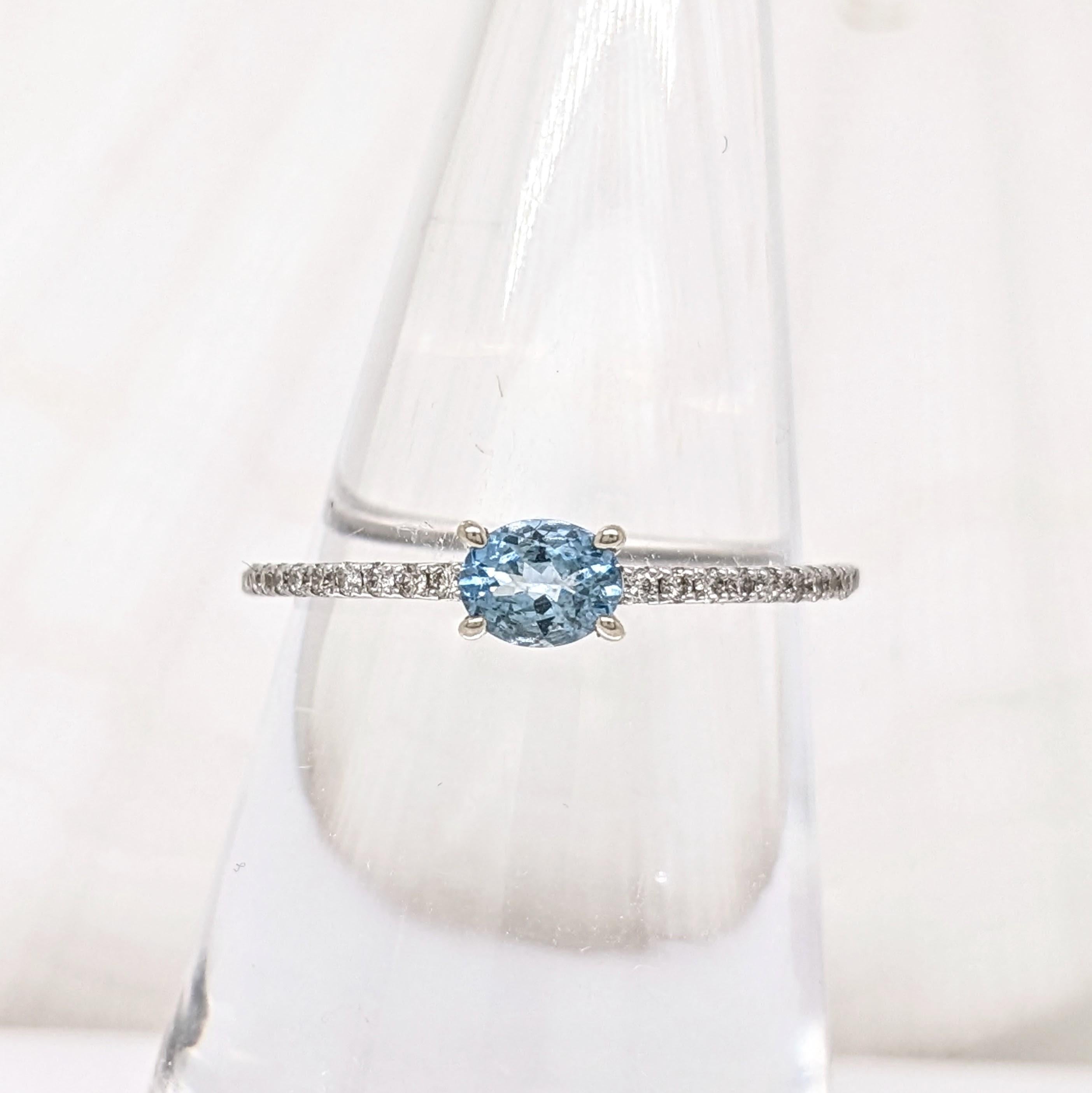 This beautiful ring features an oval east west aquamarine gemstone in 14k yellow gold with natural earth-mined diamonds. A dainty ring design perfect for an eye catching engagement or anniversary. Aquamarine does not only make a beautiful March