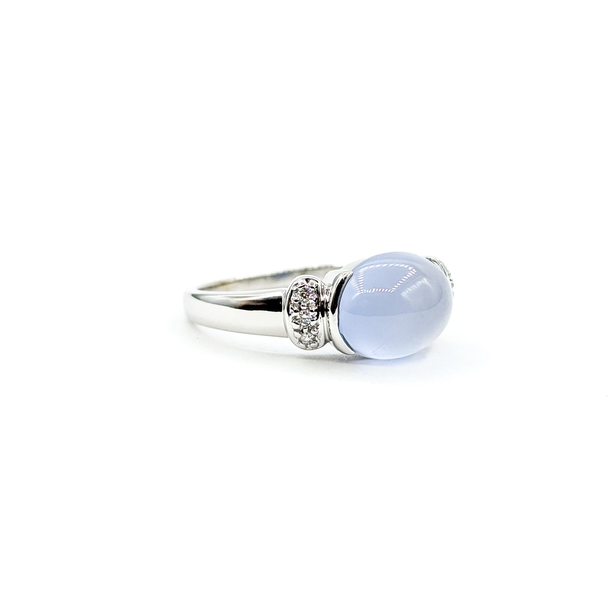 Anillo de calcedonia y diamantes East West de 14k

Este anillo está elaborado en oro blanco de 14 quilates y presenta una calcedonia engastada en talla cabujón lisa. La calcedonia pesa aproximadamente 1,4 ct y muestra un tono azul suave y sereno.