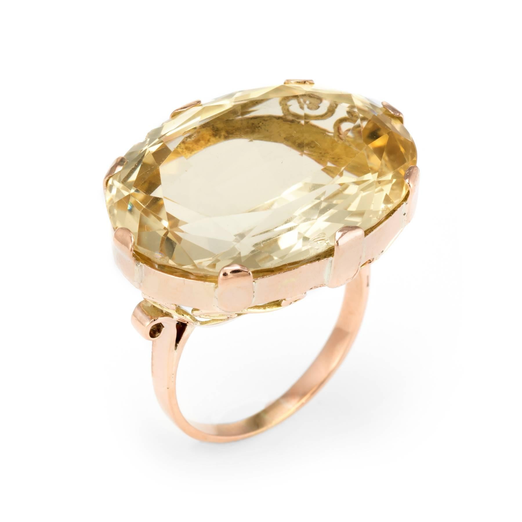 Bold and distinct east west facing vintage cocktail ring (circa 1950s), crafted in 10 karat rose gold. 

Faceted oval cut citrine measures 24mm x 18mm (estimated at 30 carats). Note: slight chips to the citrine (visible under a 10x loupe).   

The