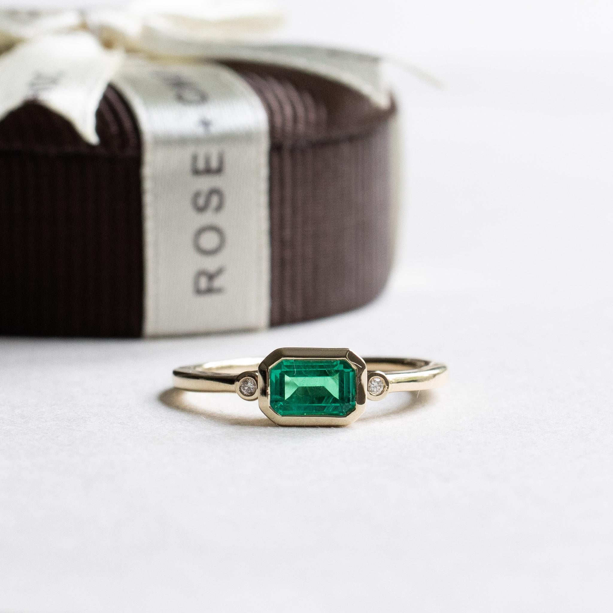 east west engagement ring emerald