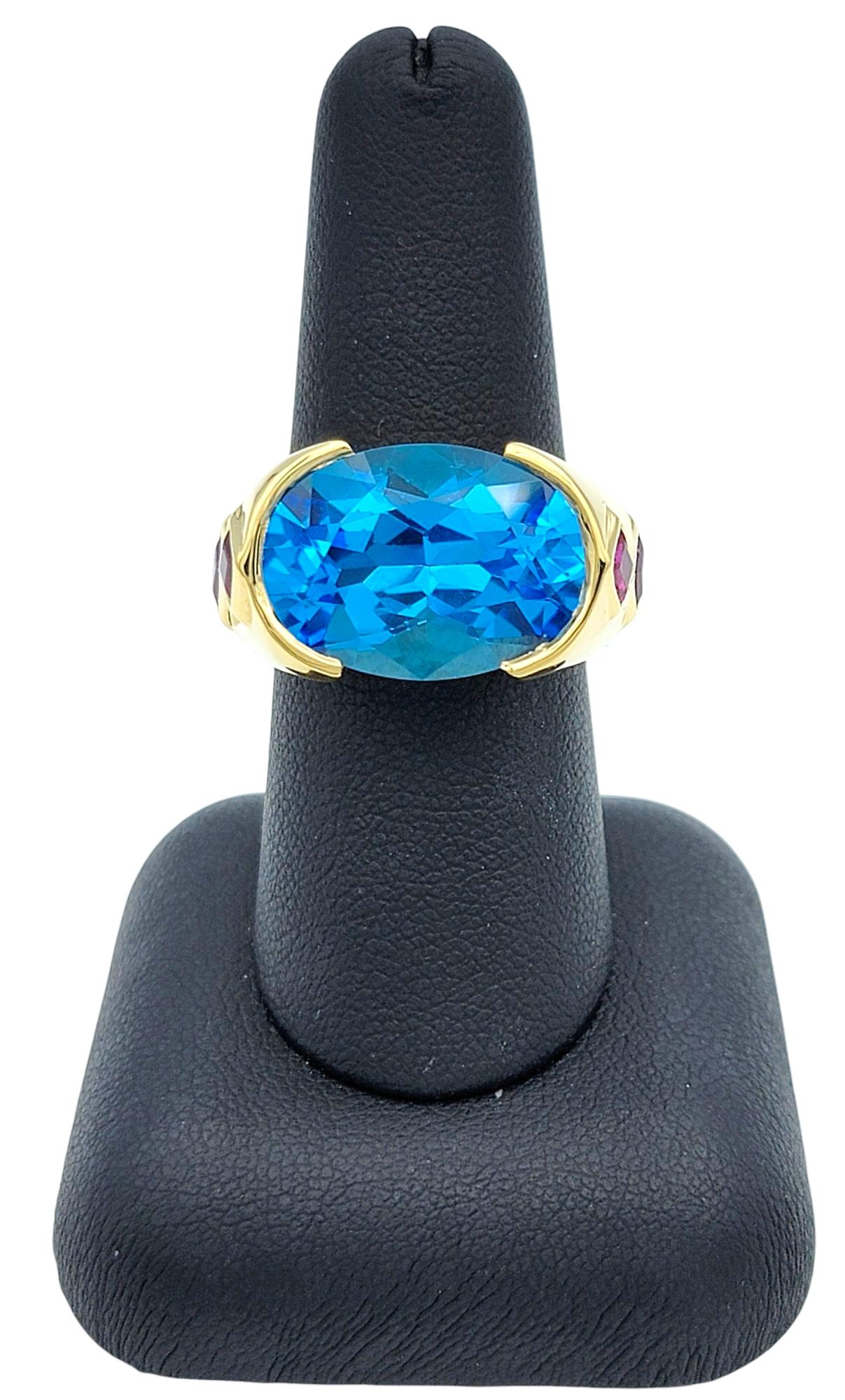East West Oval Cut Blue Topaz Cocktail Ring with Rubies in 18 Karat Yellow Gold For Sale 5