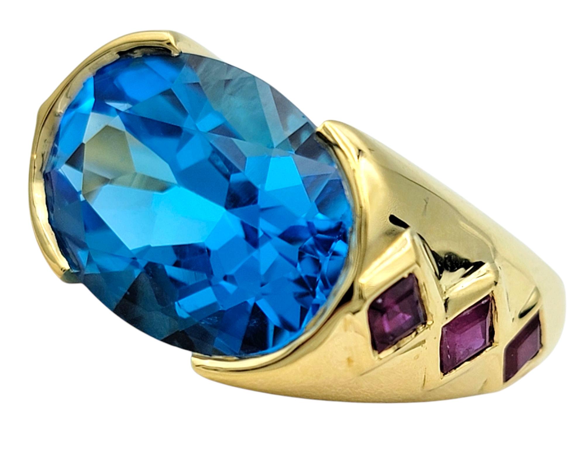 East West Oval Cut Blue Topaz Cocktail Ring with Rubies in 18 Karat Yellow Gold In Good Condition For Sale In Scottsdale, AZ