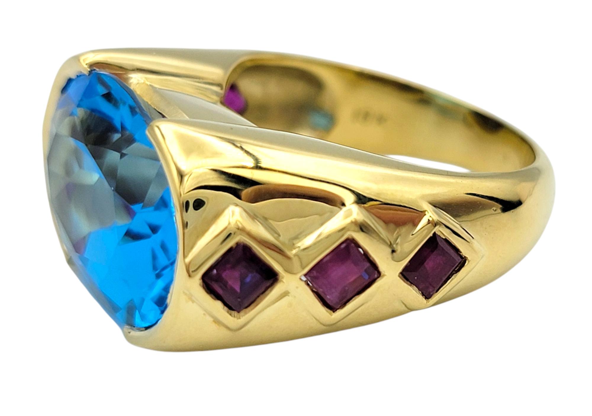 Women's or Men's East West Oval Cut Blue Topaz Cocktail Ring with Rubies in 18 Karat Yellow Gold For Sale