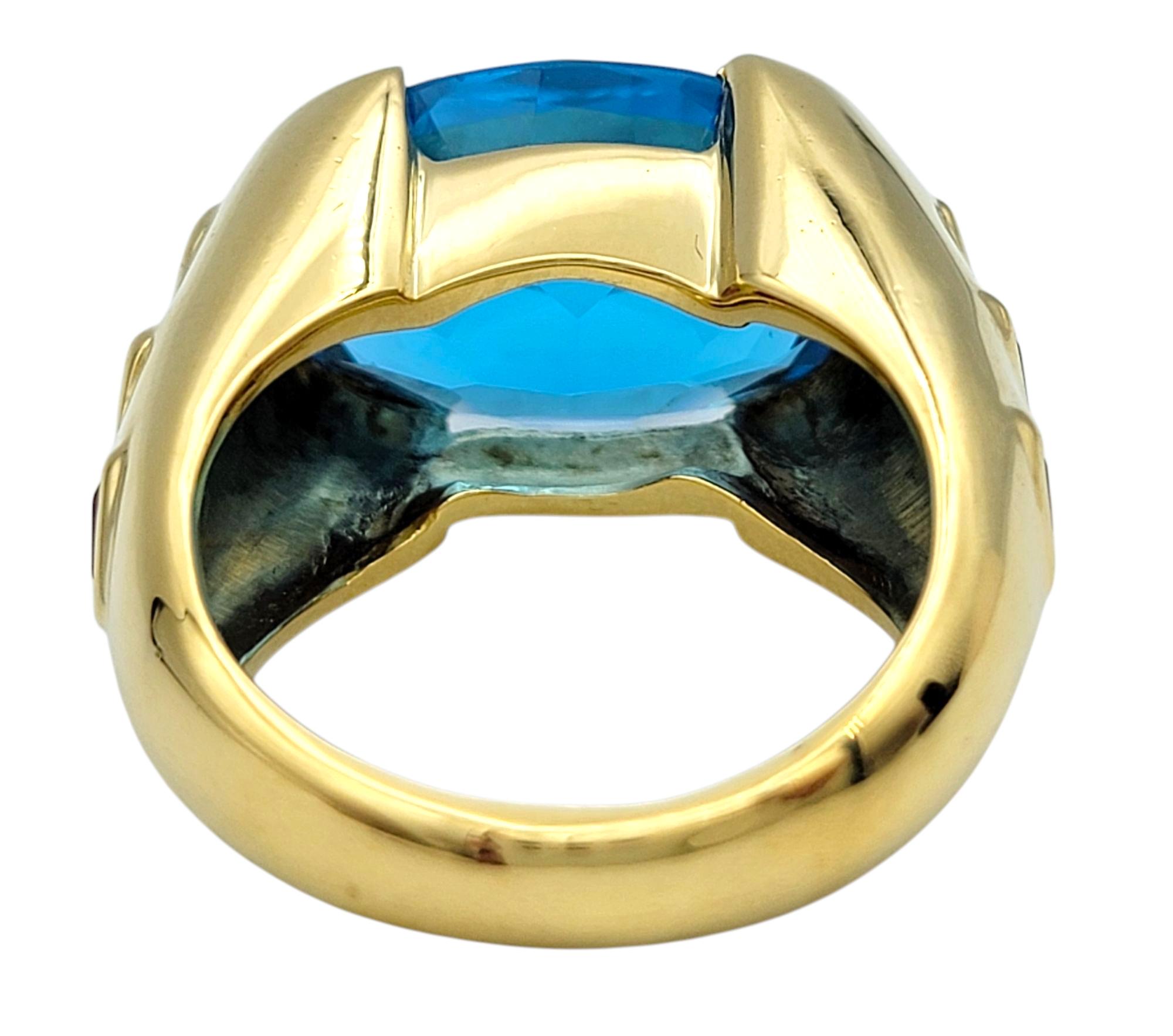 East West Oval Cut Blue Topaz Cocktail Ring with Rubies in 18 Karat Yellow Gold For Sale 1
