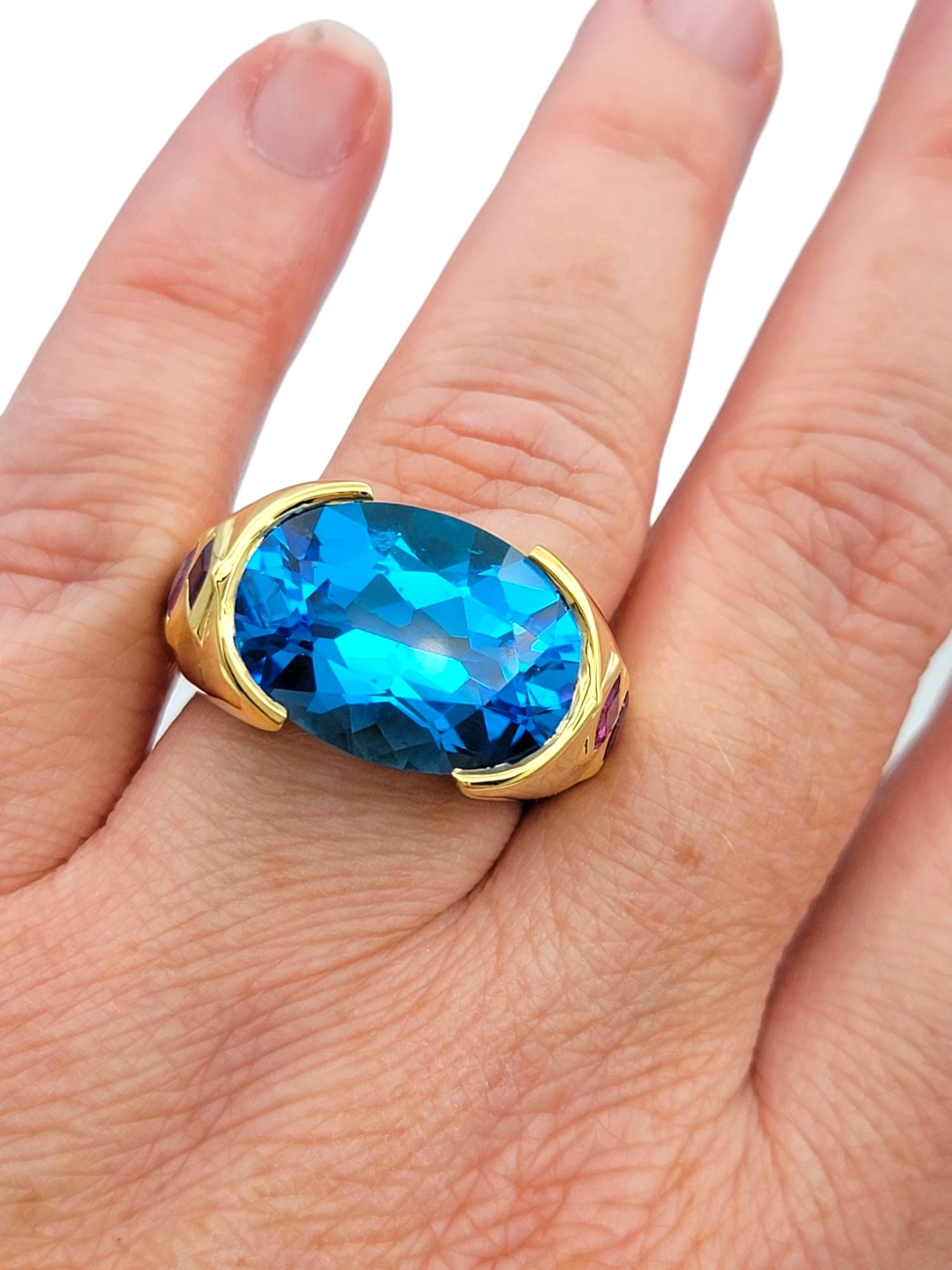 East West Oval Cut Blue Topaz Cocktail Ring with Rubies in 18 Karat Yellow Gold For Sale 4