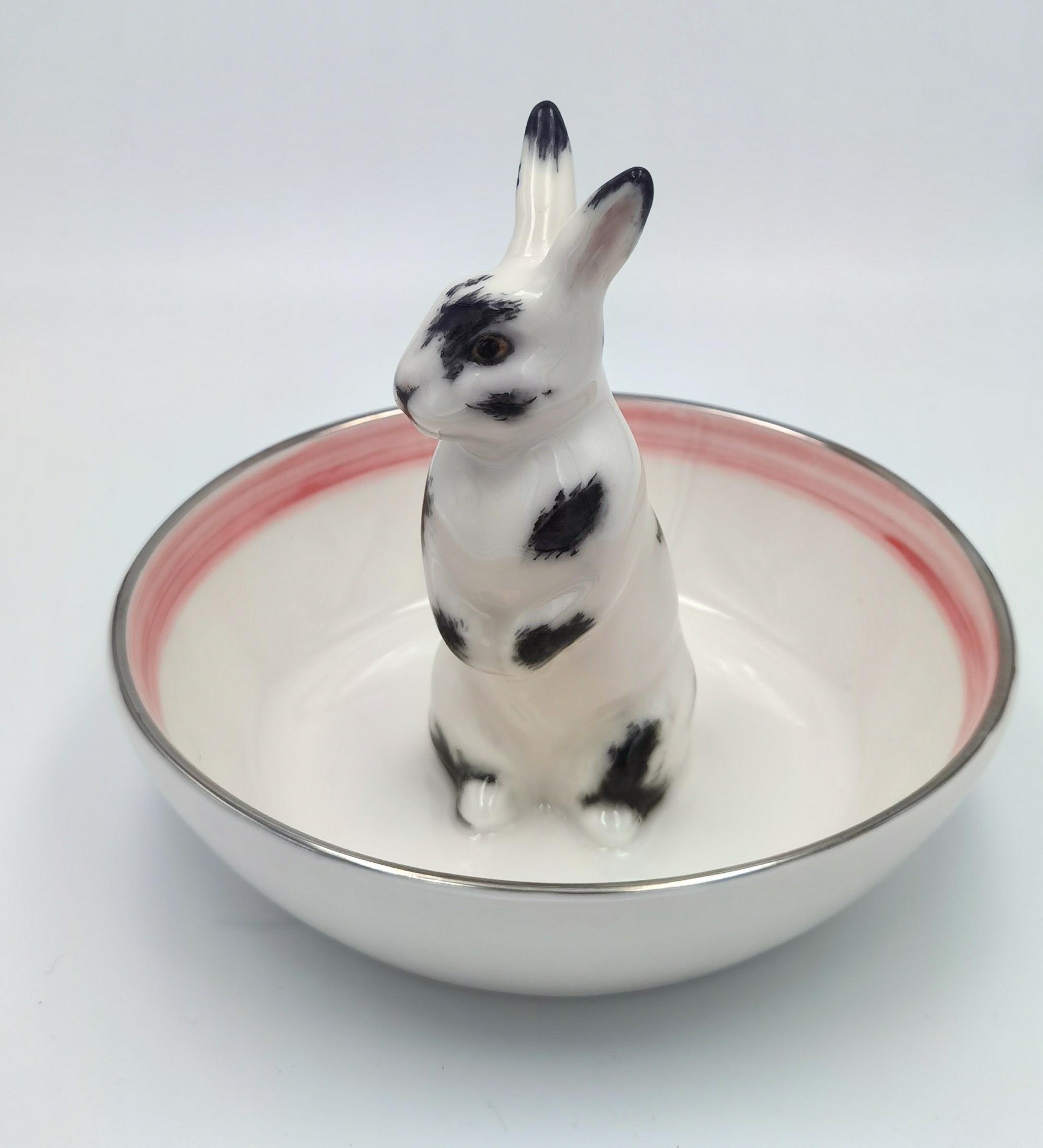 Completely handmade porcelain bowl with a hands-free naturalistic painted Easter rabbit in grey and white colors in country style. The Easter rabbit is sitting in the middle of the bowl for decorating nuts or sweets around the figure. Rimmed with a