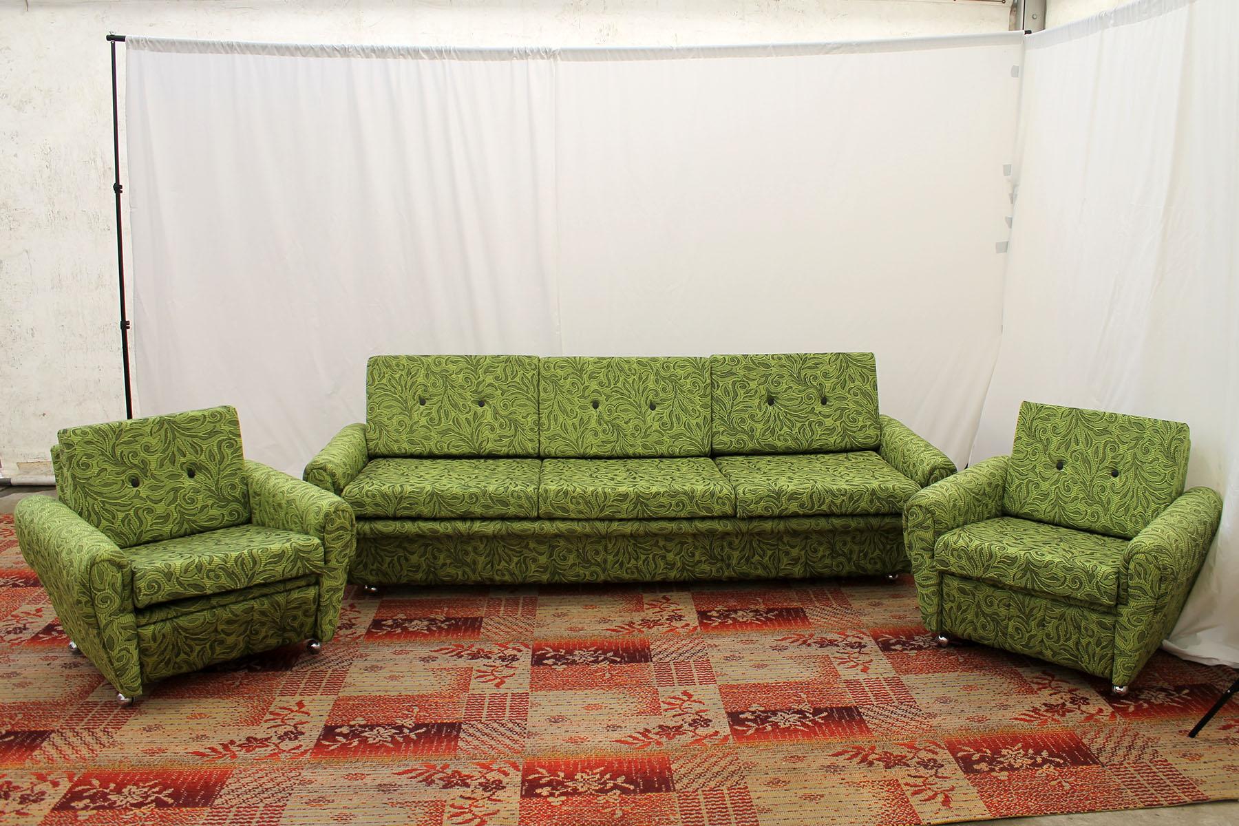 This living room set is a typical example of furniture design of the 1980s in the former Czechoslovakia. The furniture is very comfortable.
It consists of one sofa and two armchairs on wheels. The set has original green upholstery, missing three