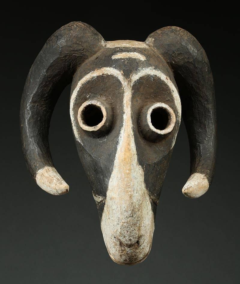 Eastern Pende Tribal Ram Mask, Congo, (DRC) 

Black and white painted ram mask, from the Eastern Pende, with tubular eyes and curved mouth and horns. Mid 20th century.  Mask: 12 1/2