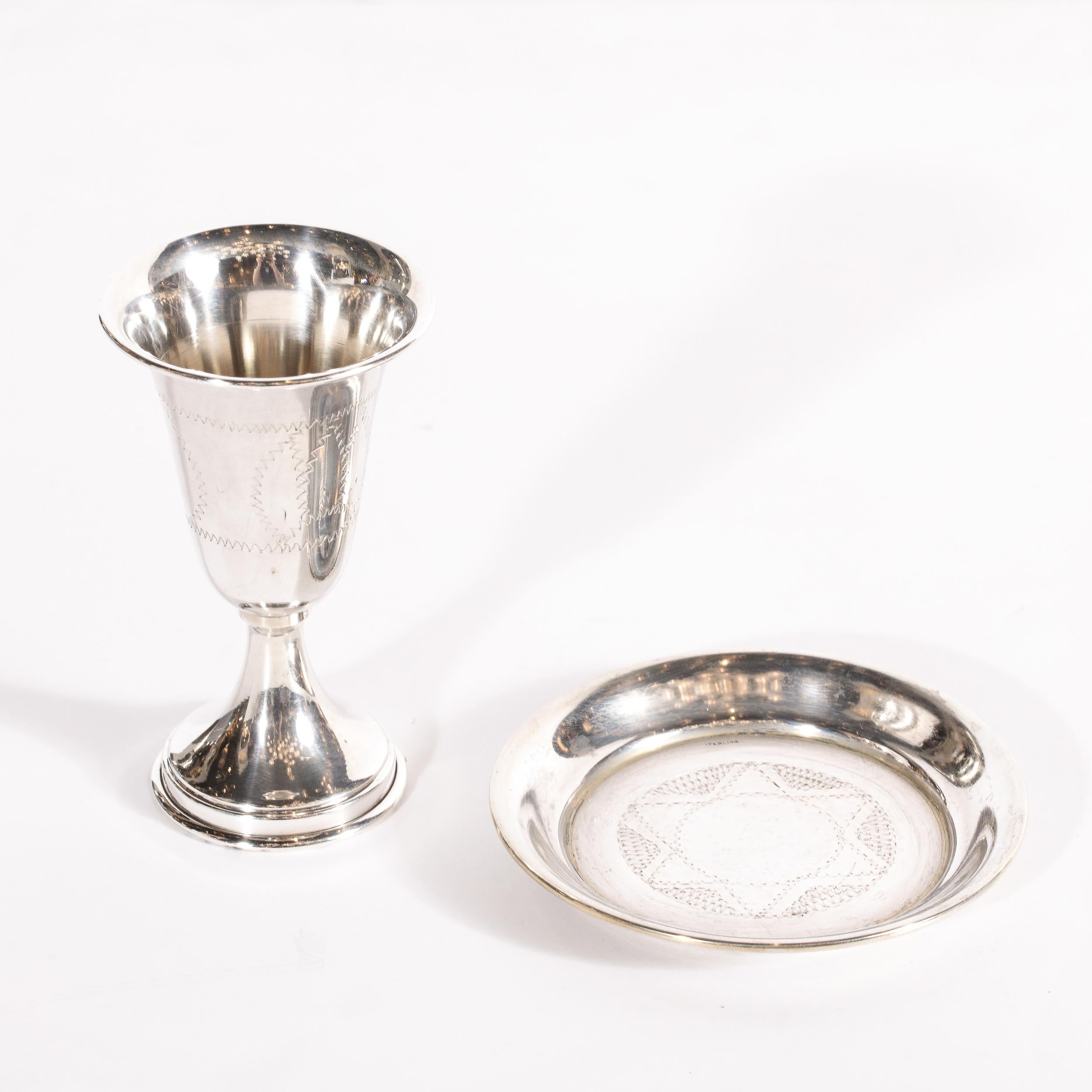 This beautiful ESCO (Eastern Sterling Company) .925 Sterling Silver Vermeil Sabath Kiddush Goblet Cup and charger were realized in the United States. The cup features a flared circular mouth and a tapered stem with hand chased designs throughout.