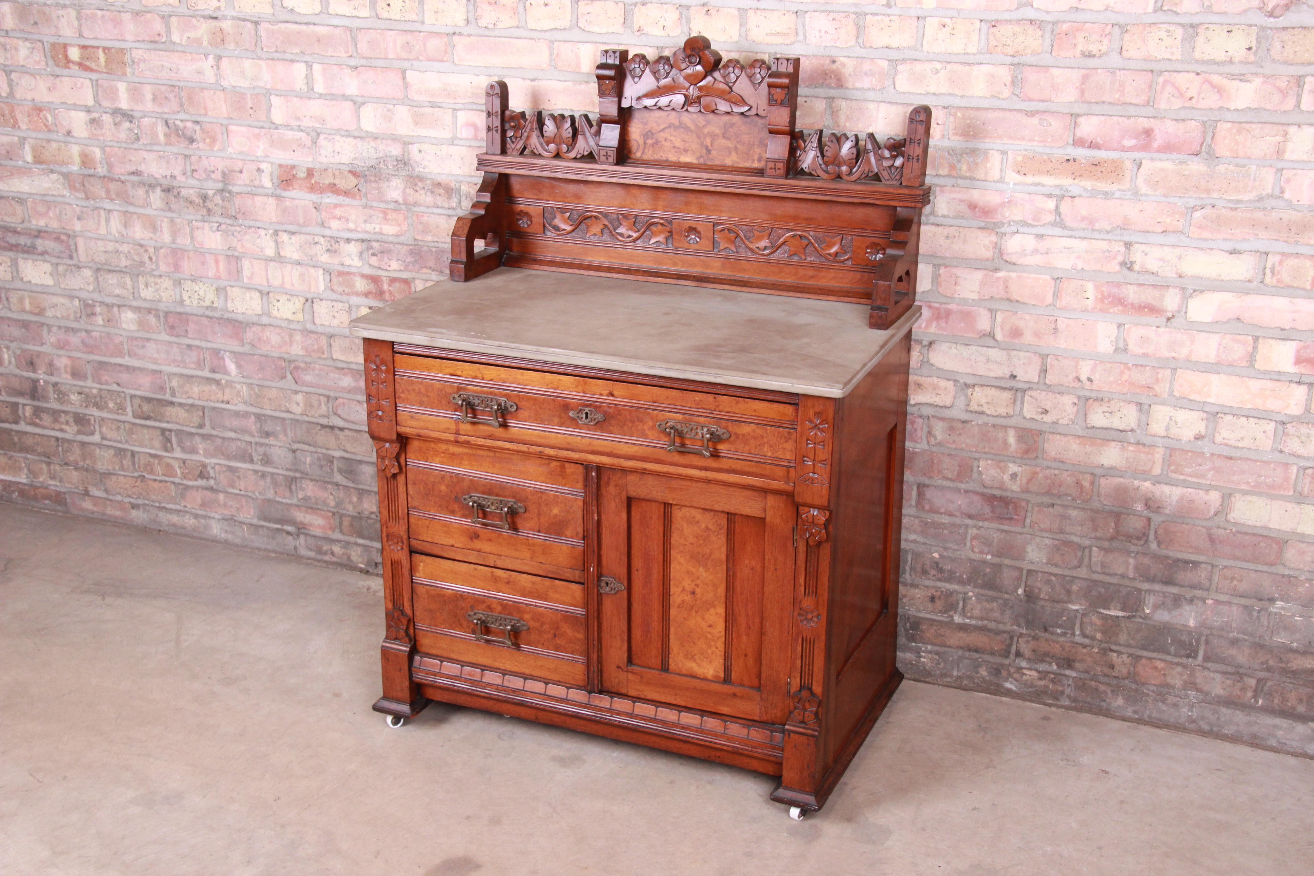 An outstanding Victorian Eastlake washstand

Originally purchased from Marshall Field's in Chicago, circa 1870

Ornate carved walnut and burl wood in floral motif, with original brass hardware, slate top, and porcelain casters.

Measures: