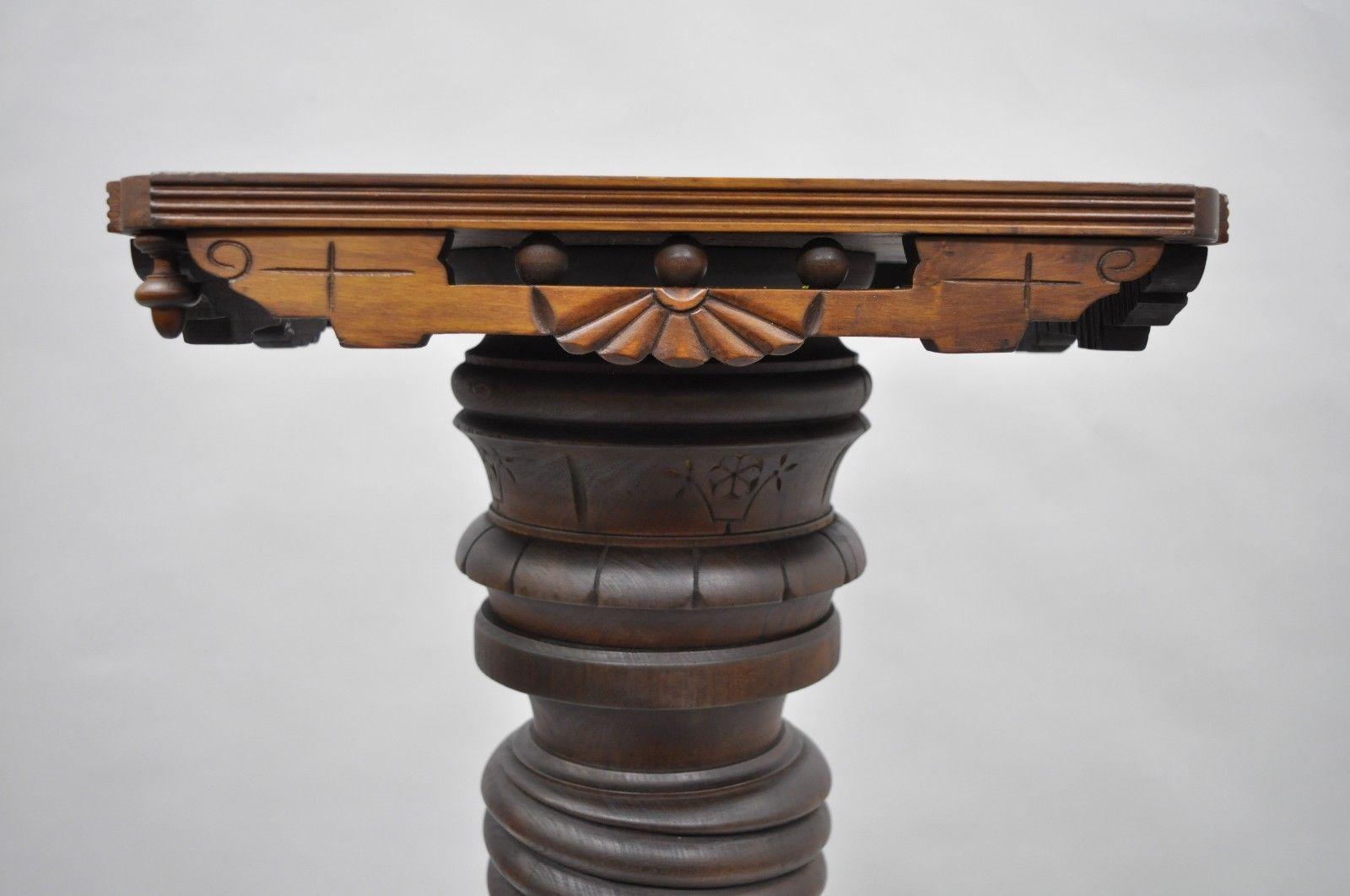 Antique Eastlake Victorian walnut spiral barley twist carved wood revolving top pedestal, circa late 19th century. Measurements:
40