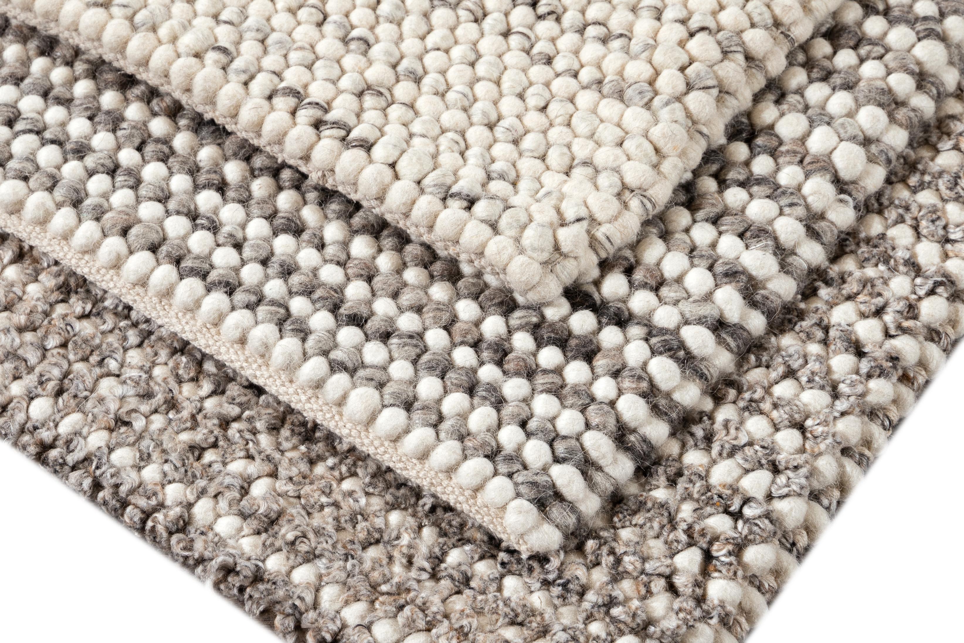 Solid-colored woven wool textured custom rug in varying neutral shades. Custom sizes and colors made-to-order. 

Collection: Easton
Material: 100% wool
Lead time: Approximate 15-20 weeks available
Colors: Greige, grey, Lt. silver made in