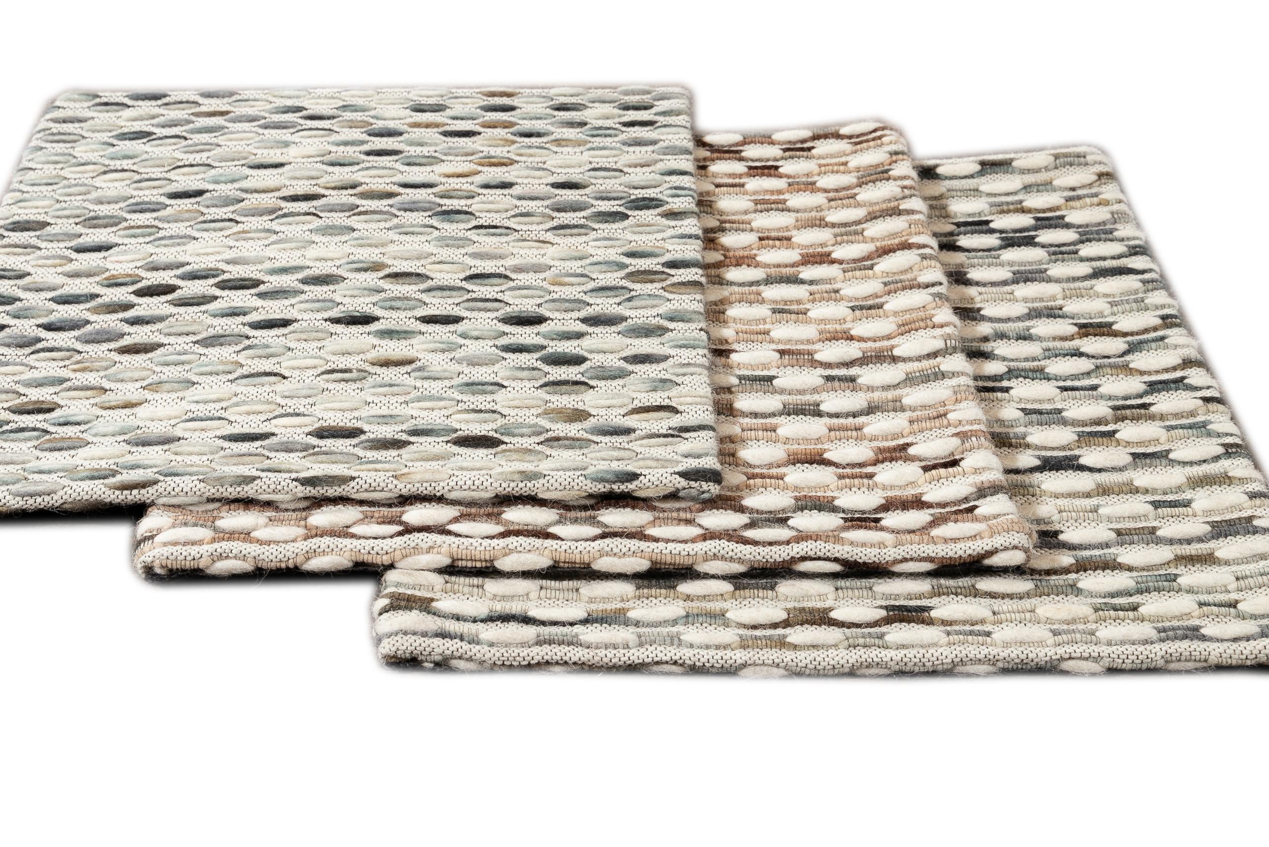 Woven felt jaquard wool textured custom rug. Custom sizes and colors made-to-order. 

Collection: Easton 
Material: Wool 
Lead time: Approx. 15-20 weeks available 
Colors: Nine color combinations 
Made in India 
Price listed is for an 8' x