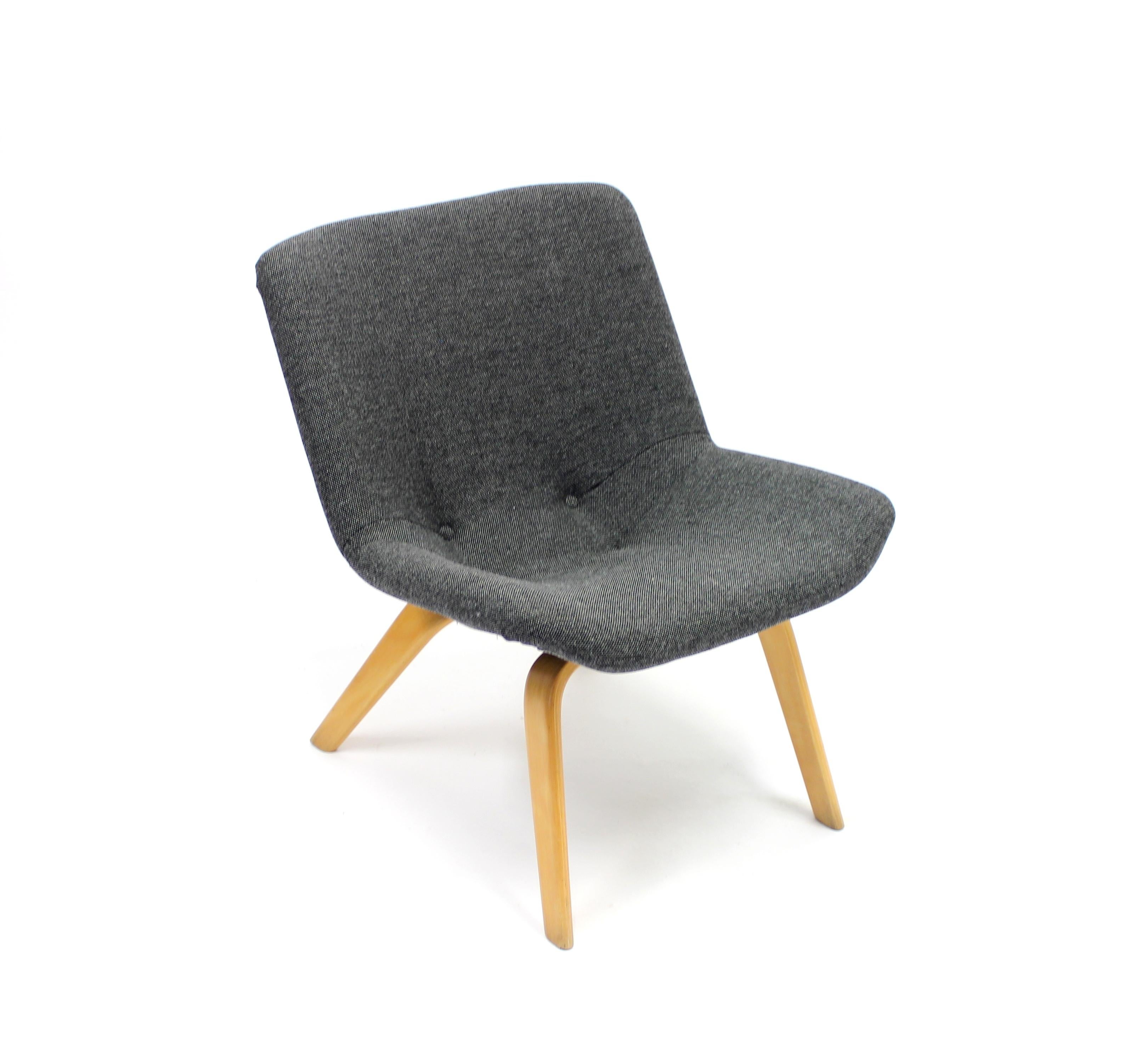 Easy chair made by Finnish designer Carl Gustaf Hiort af Ornäs for Swedish manufacturer and furniture store Gösta Westerberg in the 1950s. Neat and low model. Reupholstered in a new grey Kvadrat fabric to seat and back. Legs made of birch. Very good