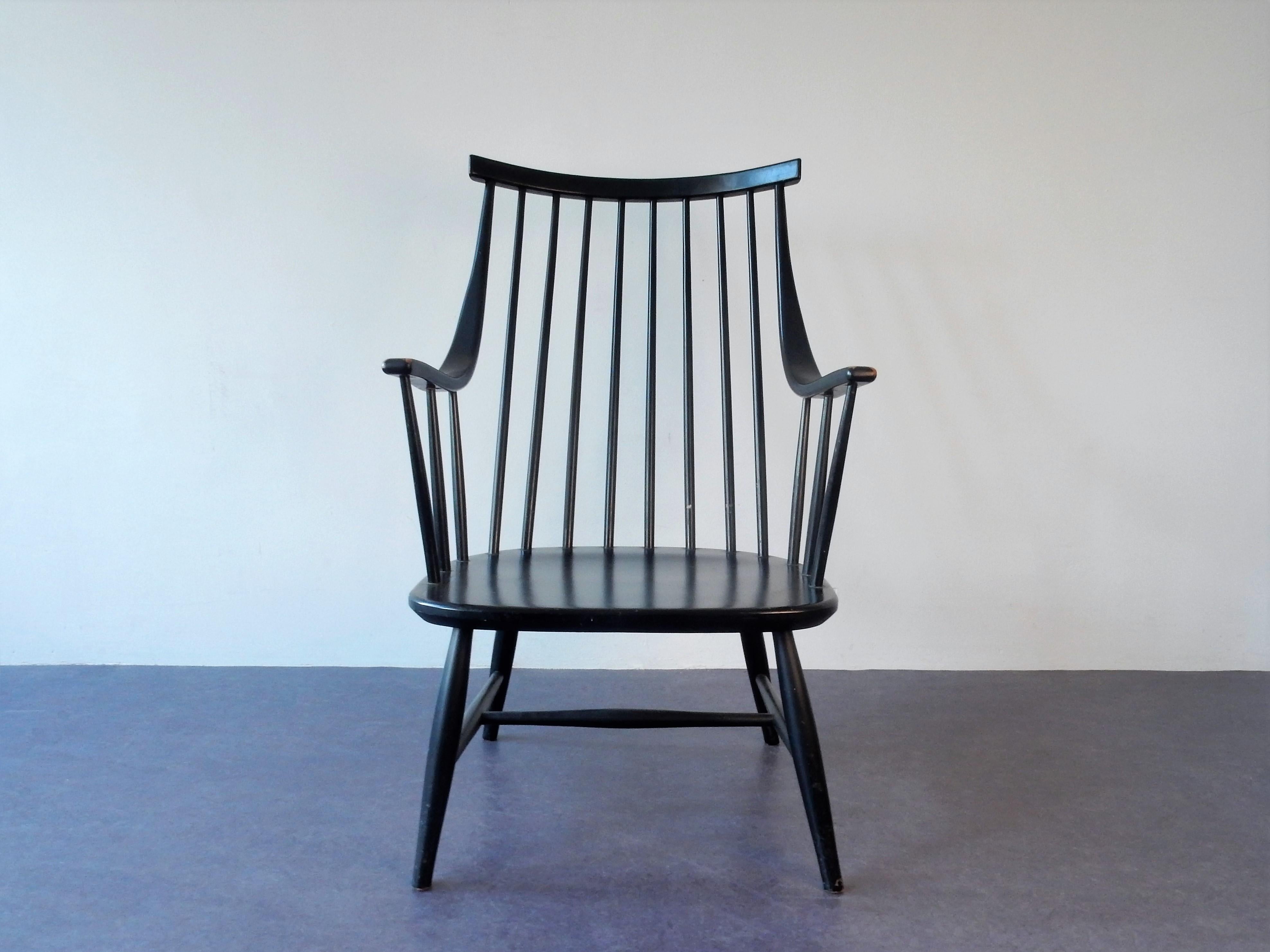 This is a very nice black lacquered spindle back armchair designed by Lena Larsson for Nesto in the 1960s in Sweden. This chair was also imported to Holland by Pastoe. The seat is marked 'Nesto' at the bottom. It is in a good condition with some