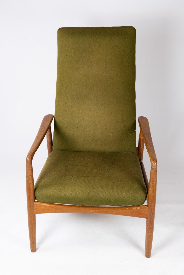 Easy chair designed by Alf Svensson and manufactured by Fritz Hansen in the 1960s. The chair is of teak and upholstered with green fabric.